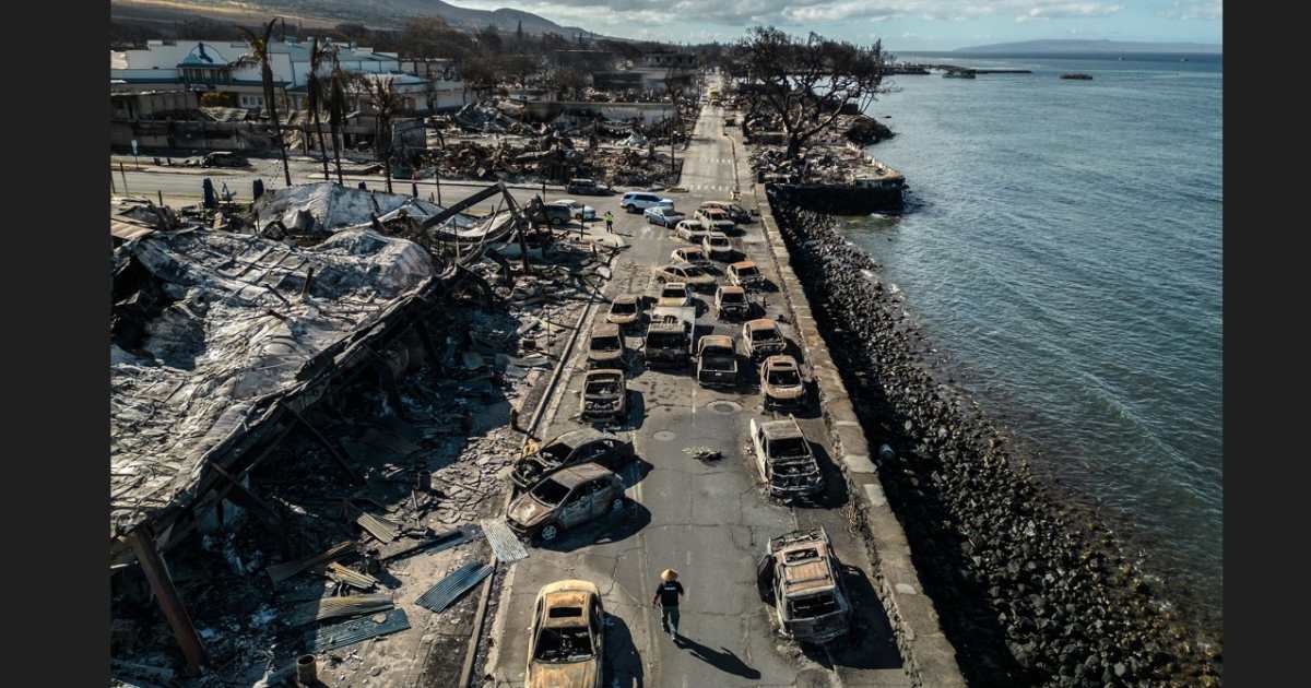 Un agente de policía camina entre restos de autos destruidos en la calle Front de Lahaina, en la isla hawaiana de Maui, el miércoles 16 de agosto de 2023. (Go Nakamura/The New York Times)