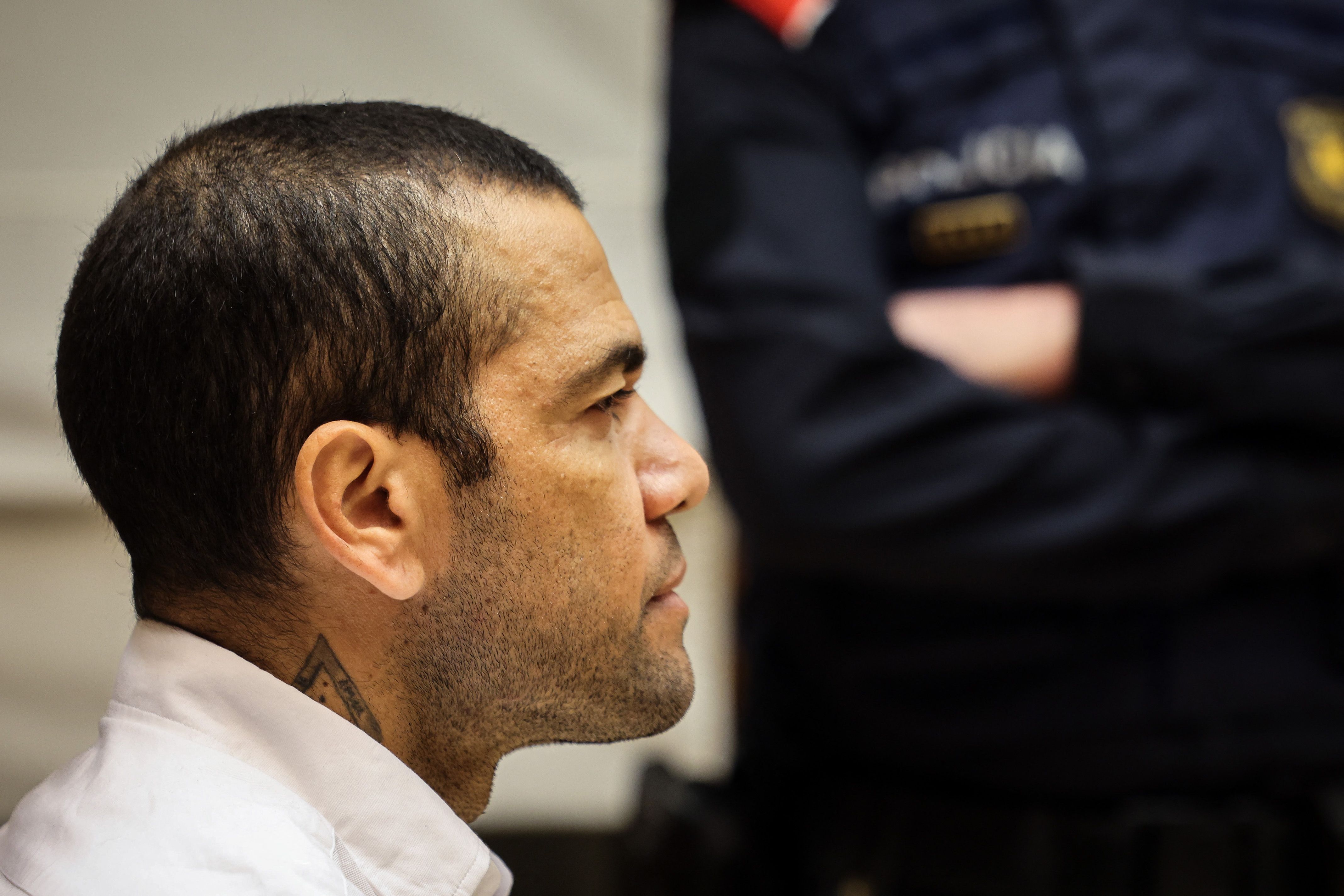 (FILES) Brazilian footballer Dani Alves looks on at the start of his trial at the High Court of Justice of Catalonia in Barcelona, on February 5, 2024. Convicted of rape, ex-Brazil star Dani Alves will be freed on bail for 1 mn euros, the court has ruled on March 20, 2024. Ex-Brazil star has been sentenced to 4.5 years in jail for rape on February 22, 2024. (Photo by Jordi BORRAS / POOL / AFP)