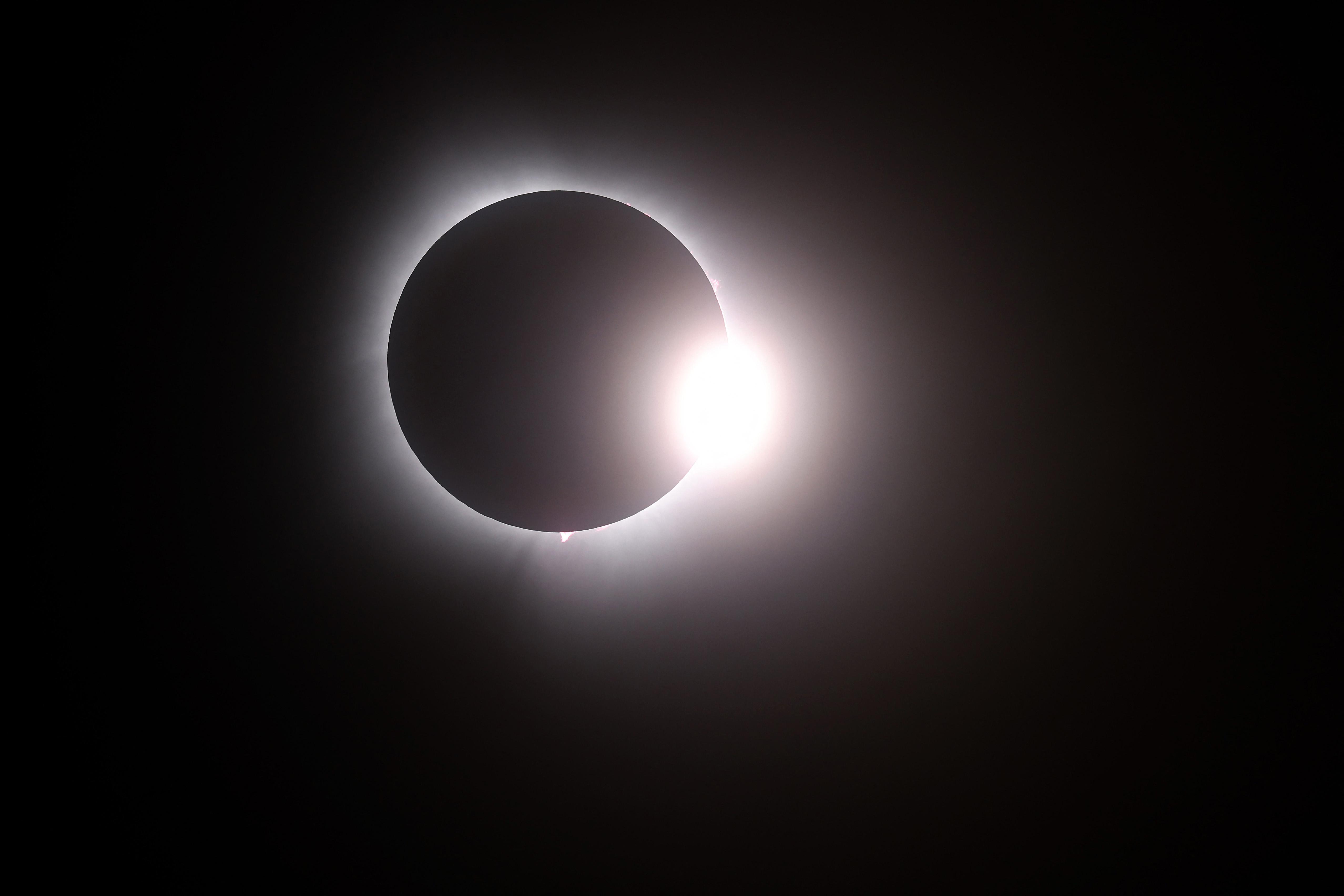 MARTIN, OHIO - APRIL 08: The moon passes in front of the sun during a solar eclipse on April 08, 2024 in Martin Ohio. Millions of people have flocked to areas across North America that are in the "path of totality" in order to experience a total solar eclipse. During the event, the moon will pass in between the sun and the Earth, appearing to block the sun.   Gregory Shamus/Getty Images/AFP (Photo by Gregory Shamus / GETTY IMAGES NORTH AMERICA / Getty Images via AFP)
