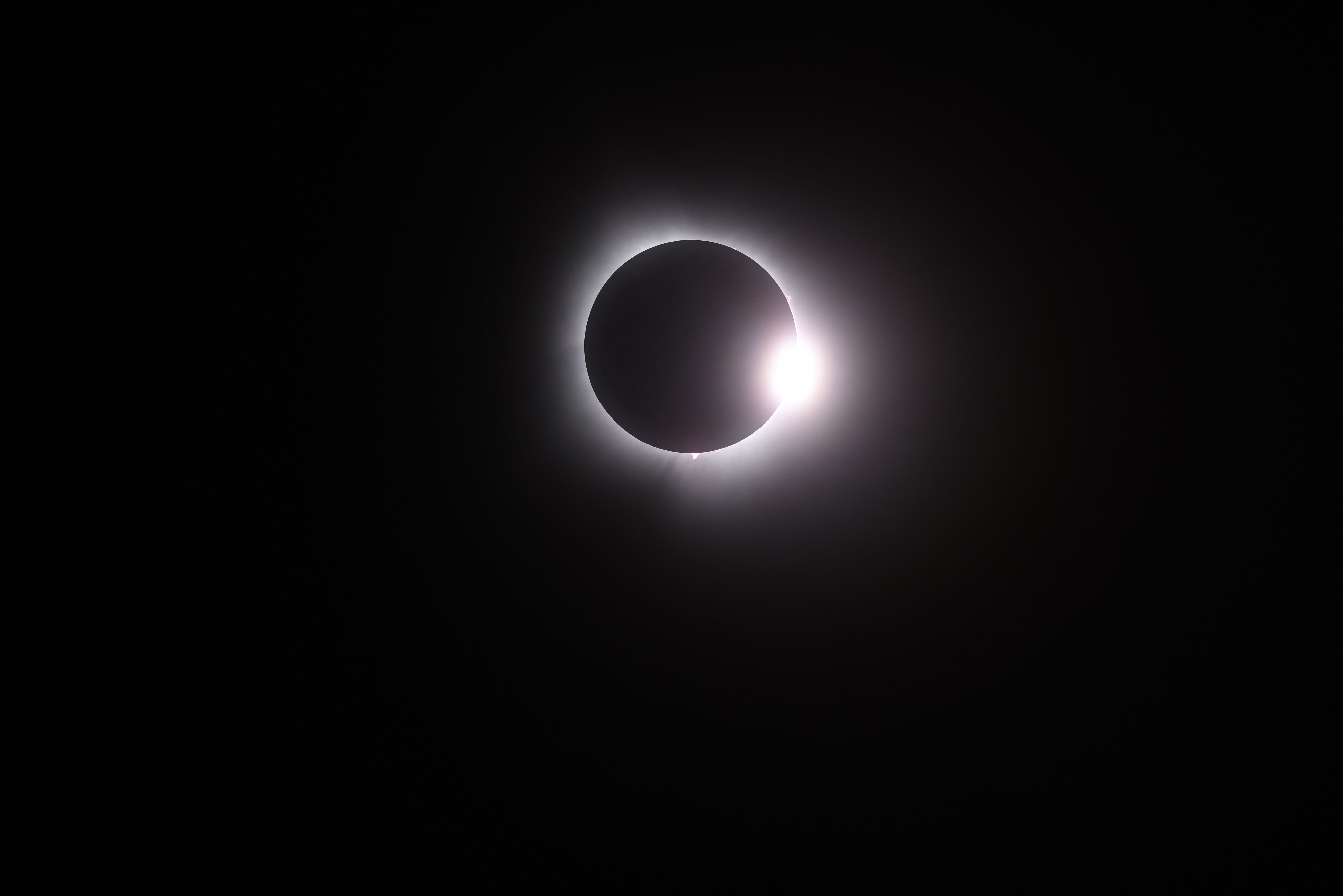 MARTIN, OHIO - APRIL 08: The moon passes in front of the sun during a solar eclipse on April 08, 2024 in Martin Ohio. Millions of people have flocked to areas across North America that are in the "path of totality" in order to experience a total solar eclipse. During the event, the moon will pass in between the sun and the Earth, appearing to block the sun.   Gregory Shamus/Getty Images/AFP (Photo by Gregory Shamus / GETTY IMAGES NORTH AMERICA / Getty Images via AFP)
