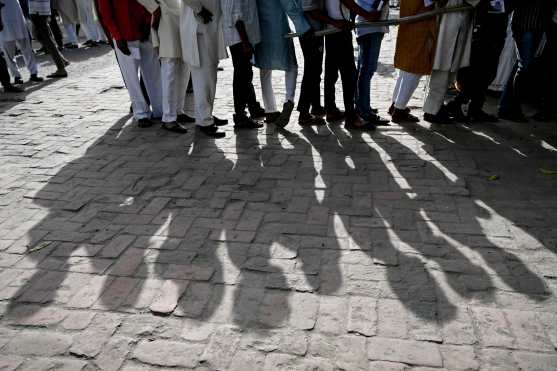People stand in a queue to cast their votes in the first phase of India's general election at a polling station in Kairana, Shamli district, in India's Uttar Pradesh state on April 19, 2024. (Photo by Sajjad HUSSAIN / AFP)