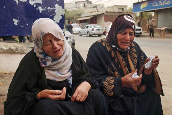 EDITORS NOTE: Graphic content / Palestinian women mourn the death of loved ones outside Al-Najjar hospital following overnight Israeli bombardment in Rafah in the southern Gaza Strip, amid the continuing conflict between Israel and Hamas on April 18, 2024. (Photo by MOHAMMED ABED / AFP)
