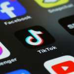 (FILES)  In this photo illustration, the TikTok app is seen on a phone on March 13, 2024 in New York City. TikTok sharply denounced the passage on April 20, 2024,  by the US House of Representatives of a bill that threatens to ban the popular social-media platform unless it severs its ties to Beijing. (Photo by Michael M. Santiago / GETTY IMAGES NORTH AMERICA / AFP)