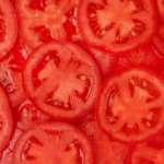 Pattern of sliced red tomato, close up.
