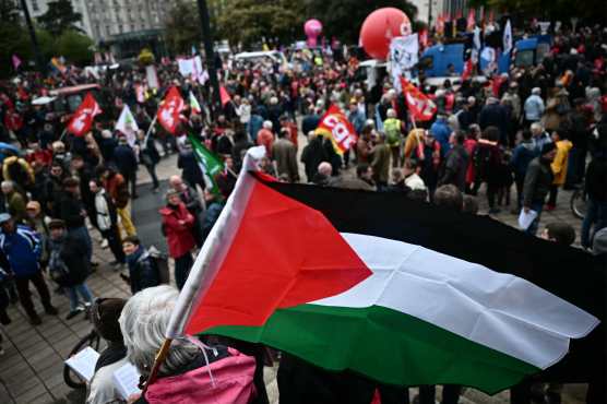 A man holds a Palestinian flag during a May Day (Labour Day) rally, marking International Workers' Day, in Nantes, western France, on May 1, 2024. (Photo by LOIC VENANCE / AFP)
