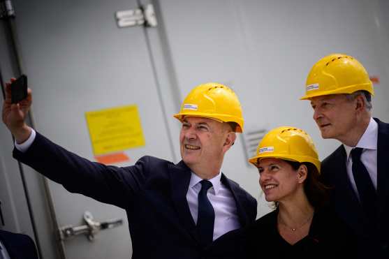 French Industry delegate minister Roland Lescure (L) takes a selfie picture with French Economy minister Bruno Le Maire (R) and Engie General director Catherine MacGregor (C) as they visit the electric powerplant for the Noirmoutier and Ile d'Yeu offshore wind farm, at the 'Chantiers de l'Atlantique' shipyards in Saint-Nazaire, western France, on May 2, 2024. (Photo by LOIC VENANCE / AFP)