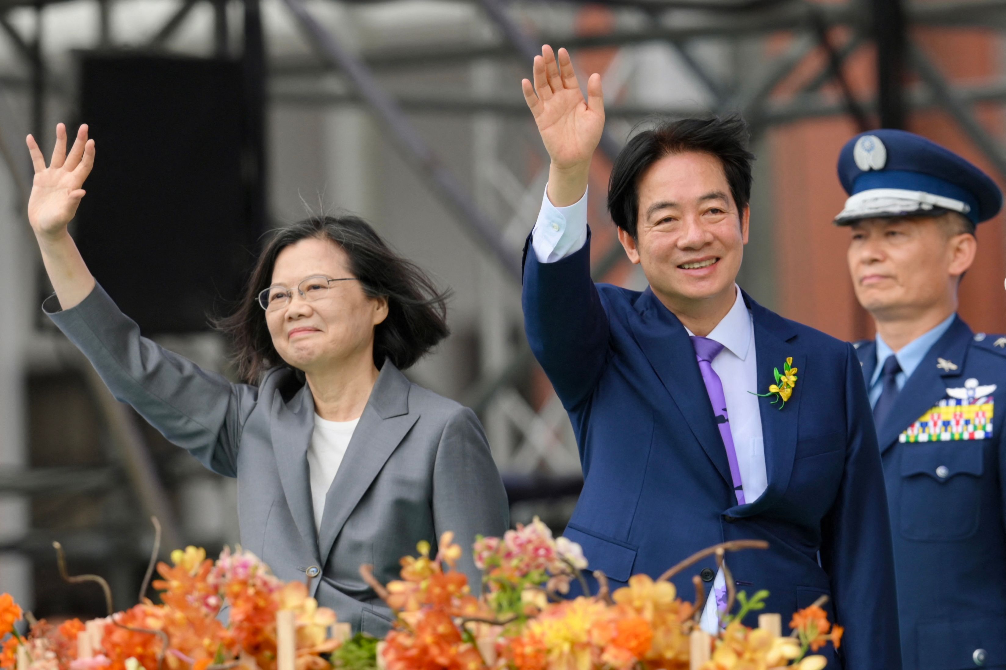 Taiwan's President Lai Ching-te (R) waves alongside outgoing president Tsai Ing-wen during the inauguration ceremony at the Presidential Office Building in Taipei on May 20, 2024. (Photo by Sam YEH / AFP)