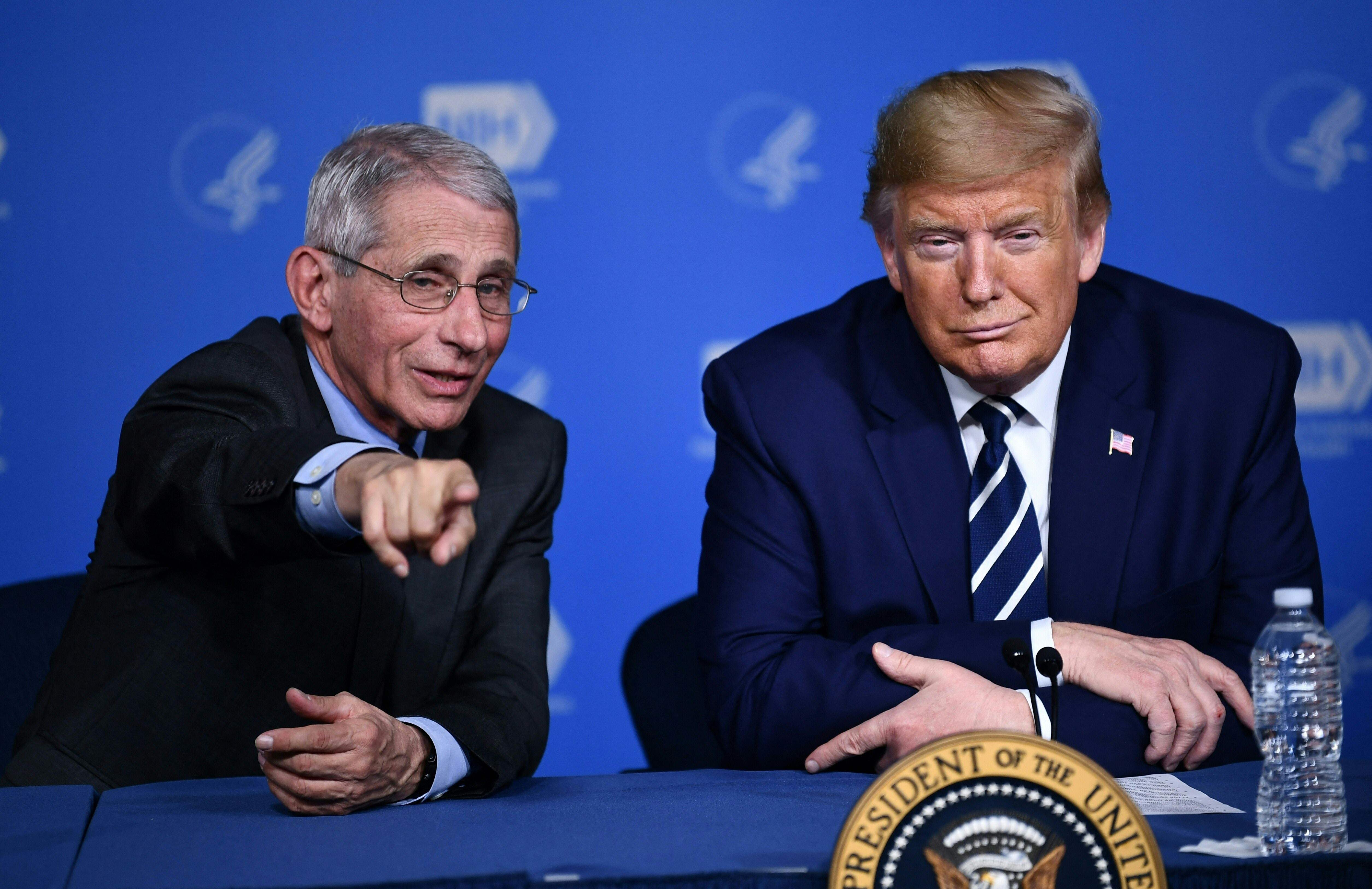 (FILES) US President Donald Trump and Anthony Fauci, director of the NIH National Institute of Allergy and Infectious Diseases attend a meeting at the National Institutes of Health in Bethesda, Maryland on March 3, 2020, following up on the COVID-19, coronavirus, outbreak. Opinion polls show Democrat Kamala Harris and Republican Donald Trump running ina statistical tie for the November 5, 2024 election, including in the seven battleground states likely to decide the national vote. (Photo by Brendan Smialowski / AFP)