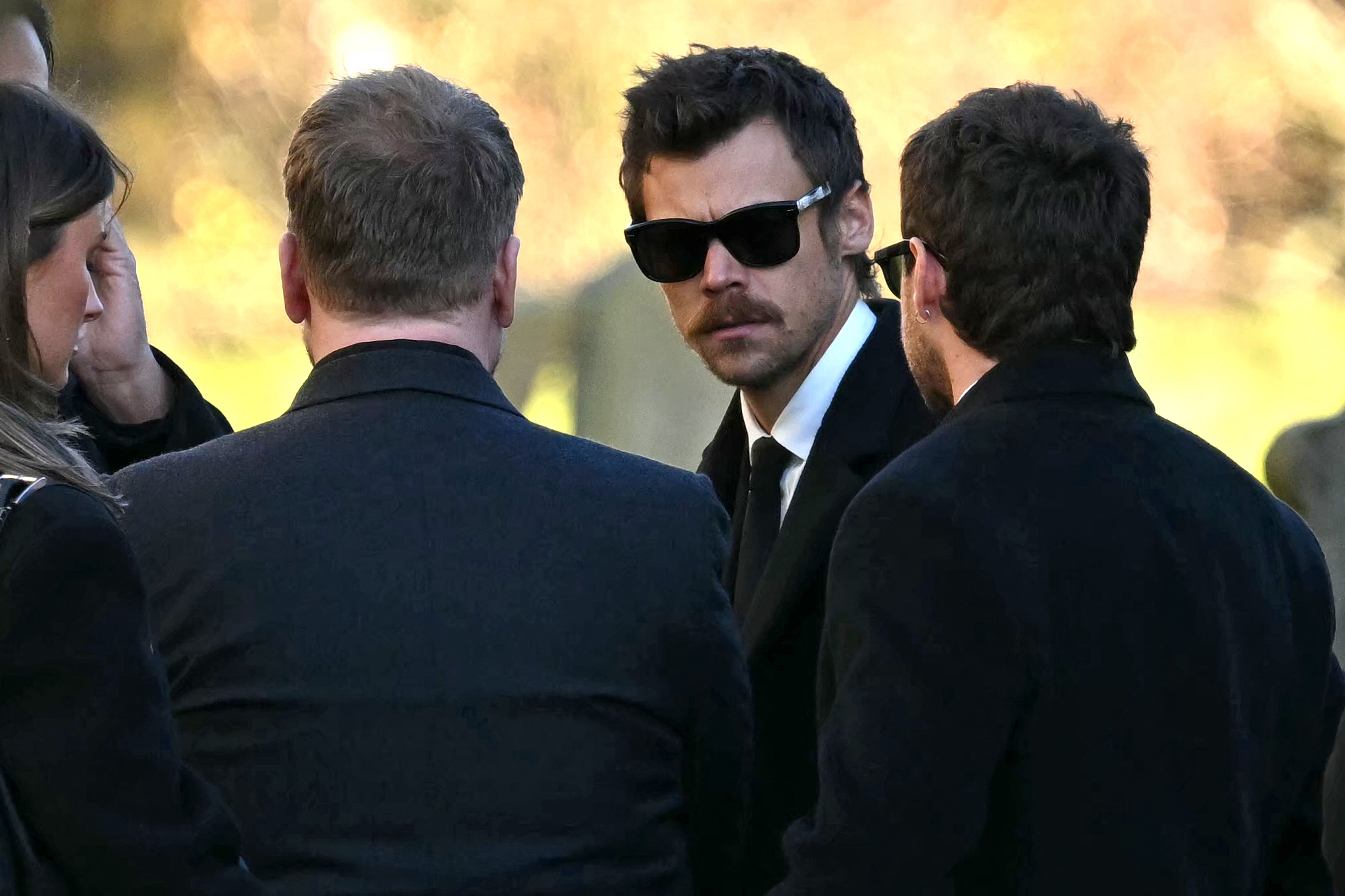 Former One Direction band members Harry Styles (C) and Niall Horan leave after attending the funeral service of the late One Direction singer Liam Payne, at a St Mary's church in Amersham, west of London on November 20, 2024. The funeral of former One Direction singer Liam Payne who died last month after falling from his Buenos Aires hotel room was held on Wednesday. (Photo by JUSTIN TALLIS / AFP)