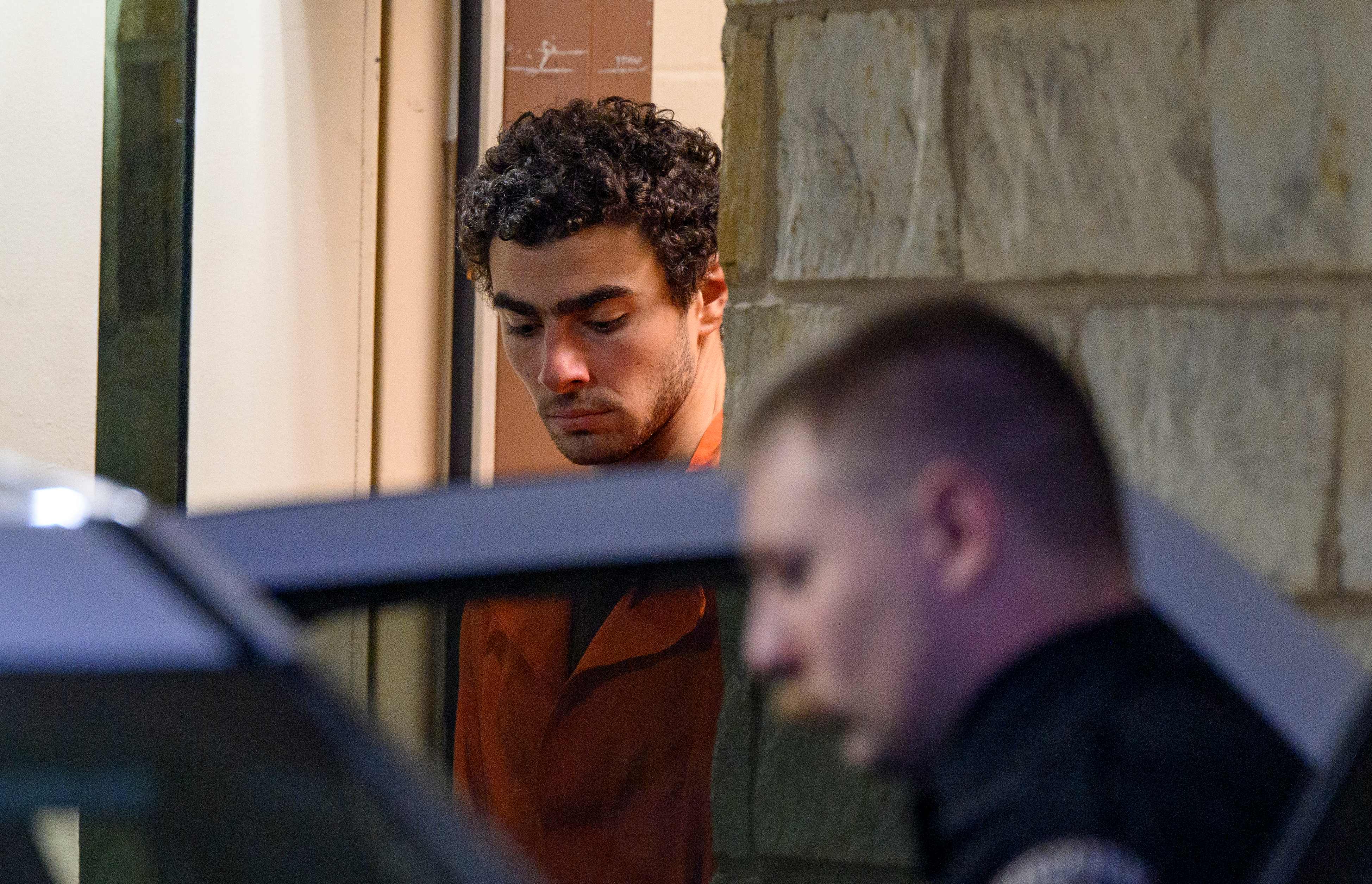 HOLLIDAYSBURG, PENNSYLVANIA - DECEMBER 10: Suspected shooter Luigi Mangione is led from the Blair County Courthouse after an extradition hearing December 10, 2024 in Hollidaysburg, Pennsylvania. Mangione has been arraigned on weapons and false identification charges related to the fatal shooting of United Healthcare CEO Brian Thompson in New York City. Mangione is incarcerated in the State Correctional Institution in Huntingdon, Pennsylvania awaiting extradition to New York.   Jeff Swensen/Getty Images/AFP (Photo by JEFF SWENSEN / GETTY IMAGES NORTH AMERICA / Getty Images via AFP)
