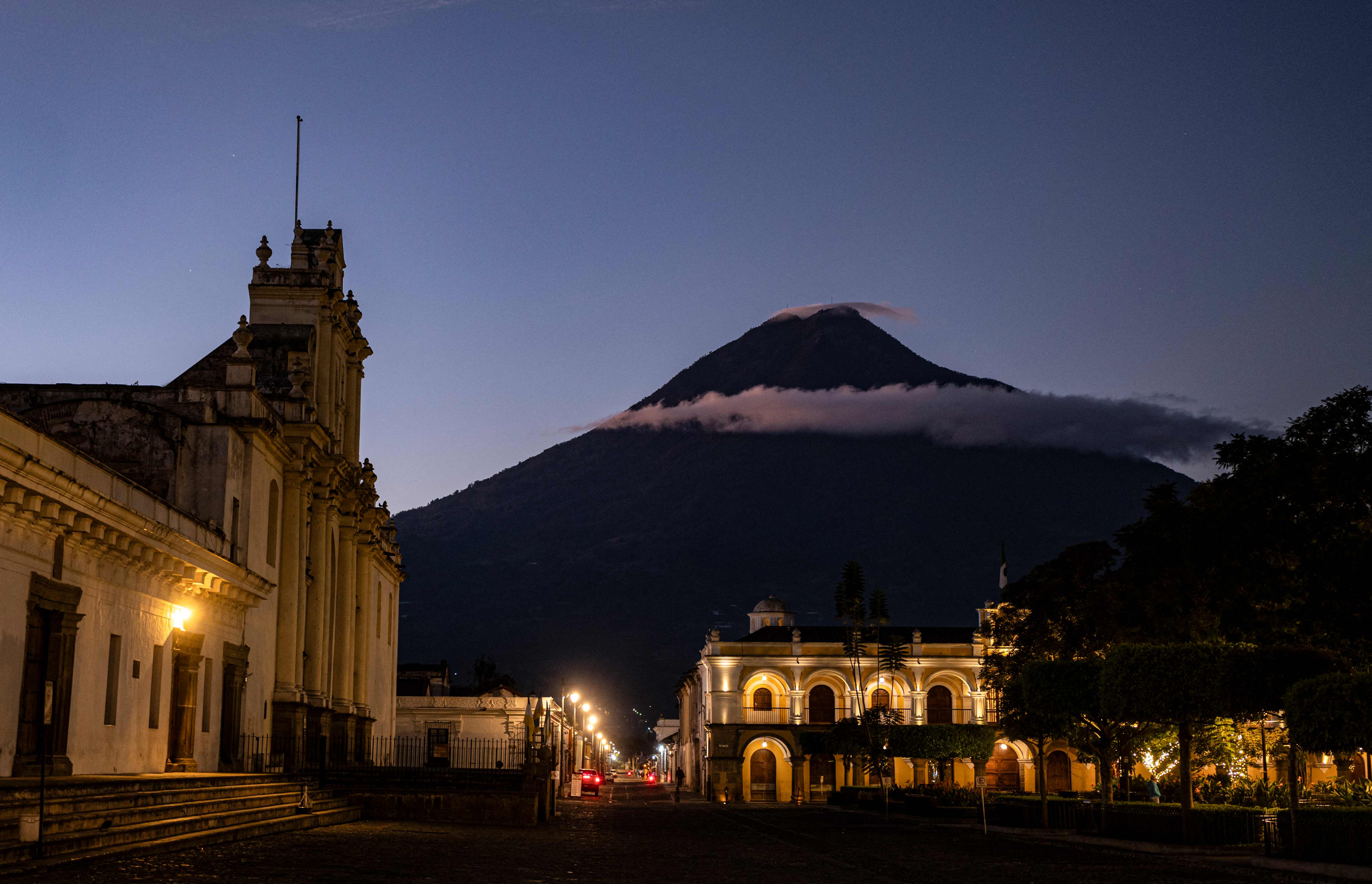 General view of San Jose cathedral and Agua volcano in Antigua, Guatemala, taken on December 12, 2024. Antigua is a small city surrounded by volcanoes in southern Guatemala. Its renowned for its Spanish colonial buildings, many of them restored following a 1773 earthquake that ended Antiguas 200-year reign as Guatemalas colonial capital. (Photo by EDWIN BERCIAN / AFP)