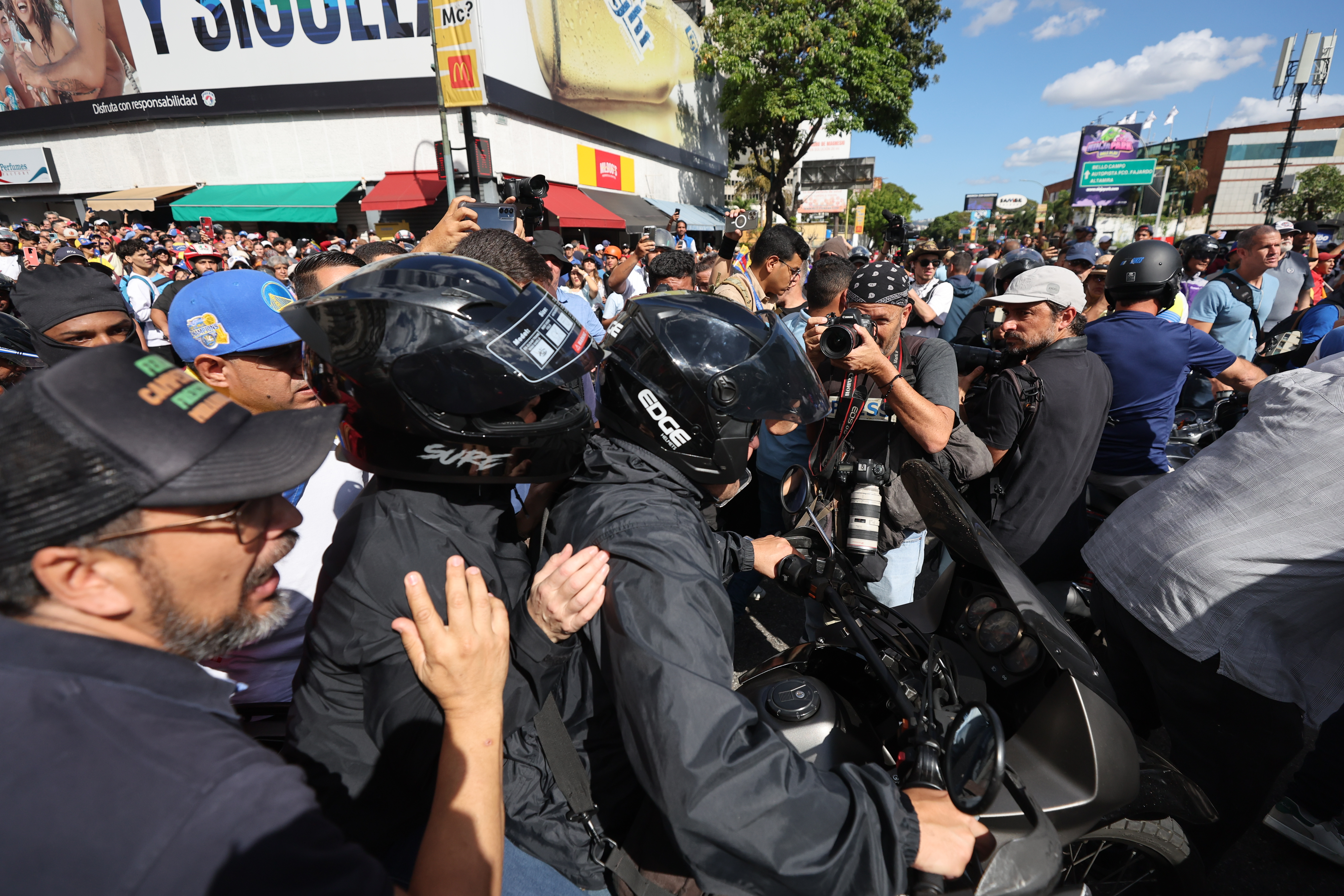 La líder antichavista María Corina Machado (casco negro) se retira de una manifestación este jueves, en Caracas, Venezuela. Machado anunció, a un día de la toma de posesión presidencial, el comienzo de una 