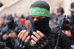 A fighter of the Ezzedine al-Qassam Brigades, Hamas's armed wing, prays during the funeral of two fighters, in Gaza City on January 24, 2025, after a ceasefire deal in the war between Israel and Hamas in the coastal Palestinian territory. A senior Hamas official told AFP that his group will provide on January 24, the names of four Israeli women hostages to be freed the following day as part of a second release under the ceasefire with Israel. The truce, the second in the more than 15 months of war, began on January 19, with the first three hostages released in exchange for around 90 Palestinian prisoners. (Photo by Omar AL-QATTAA / AFP)