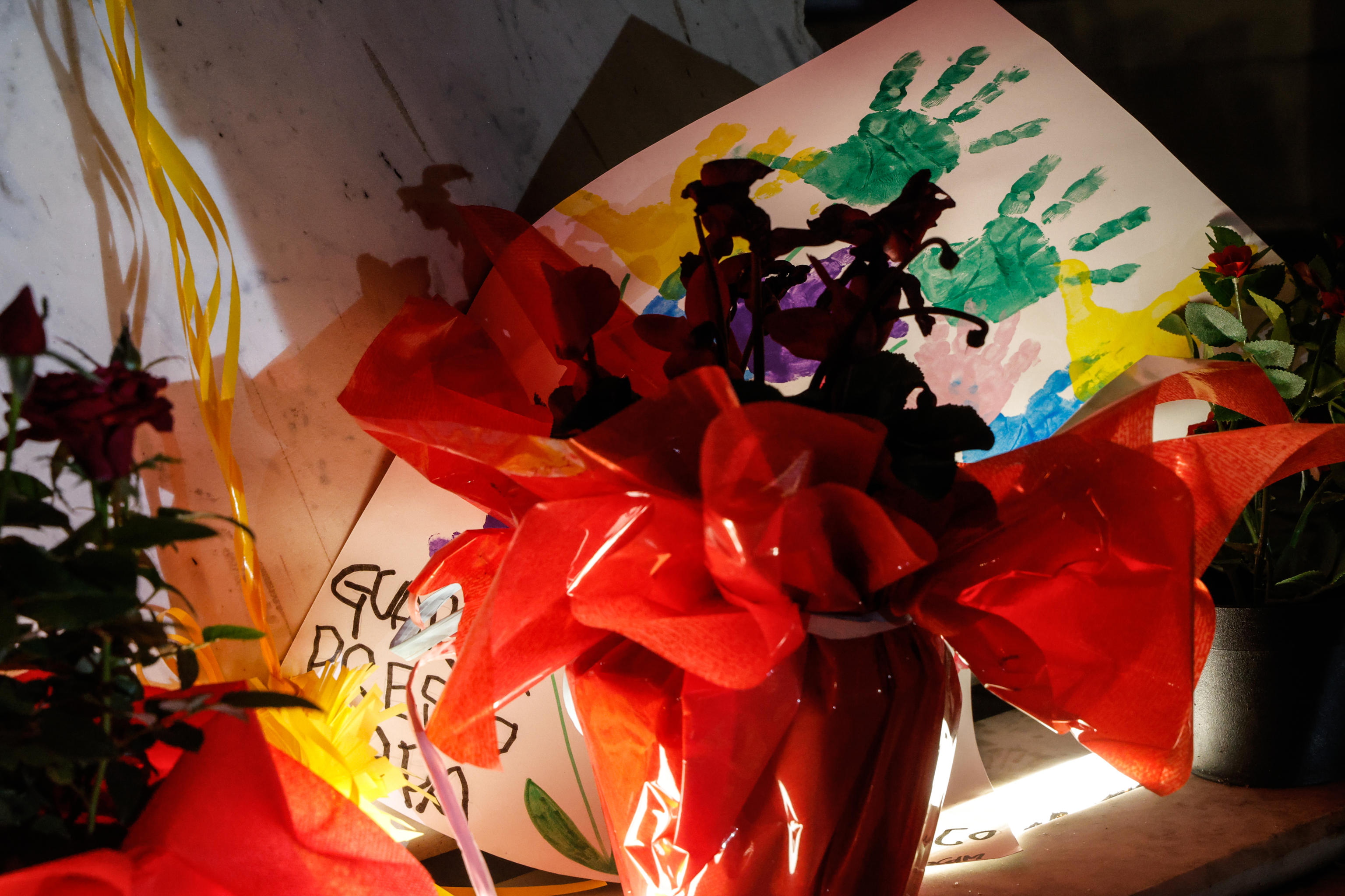 Velas y dibujos bajo la estatua del difunto Papa Juan Pablo II en las afueras del Hospital Agostino Gemelli, donde el Papa Francisco está hospitalizado en Roma. (Foto Prensa Libre: AFP)