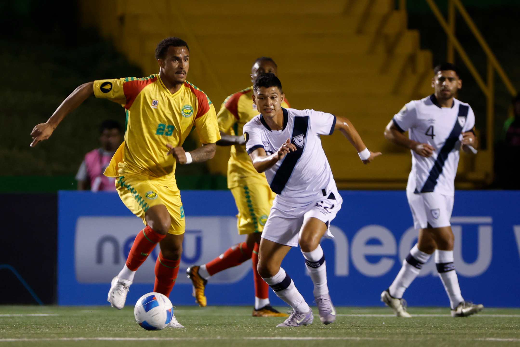 Jonathan Franco (D) from Guatemala disputes a ball with Elliot Bonds in Guyana.