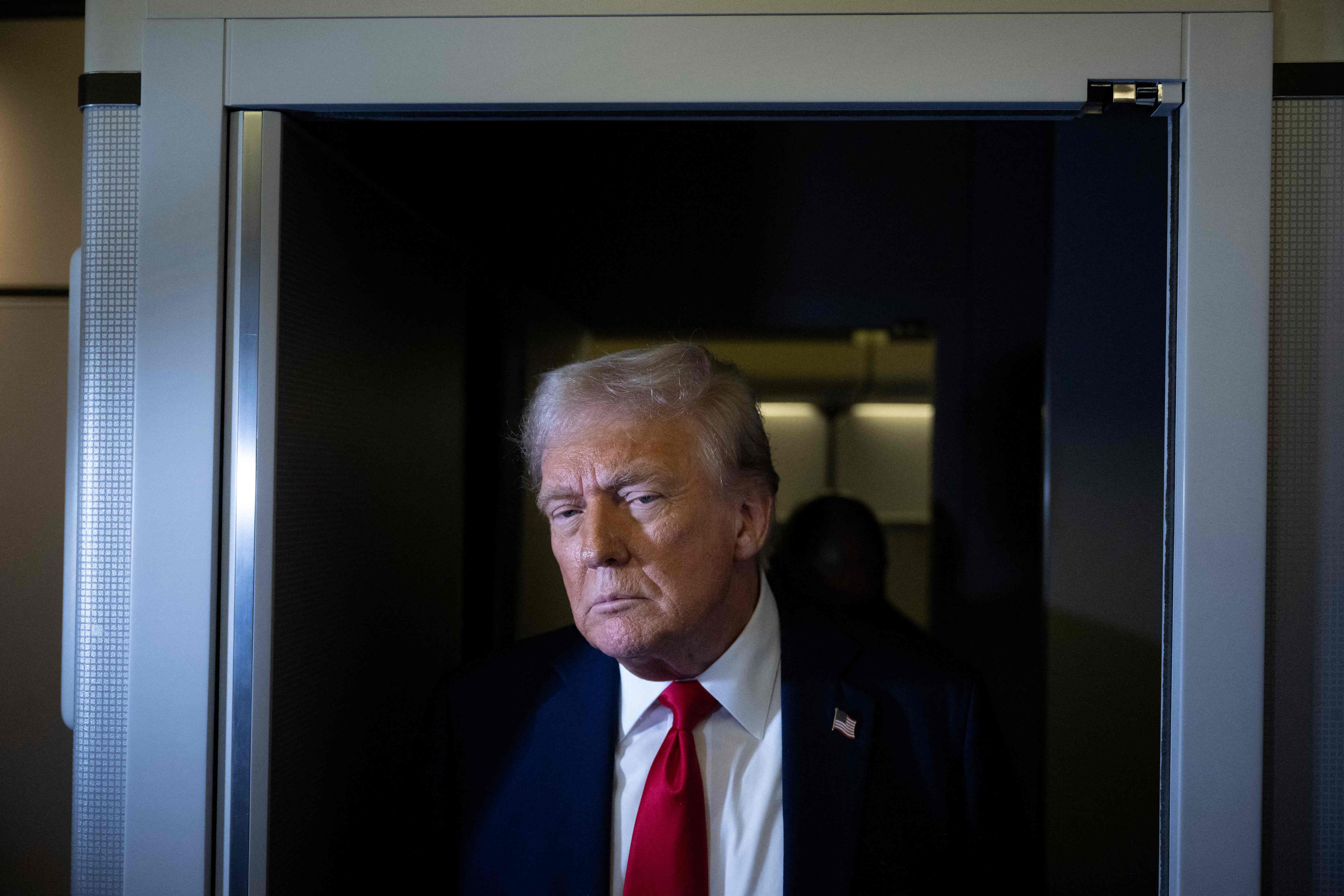 US President Donald Trump speaks to members of the press while returning to Washington, DC on Air Force One on March 30, 2025, in Fredericksburg, Virginia. (Photo by Brendan Smialowski / AFP)