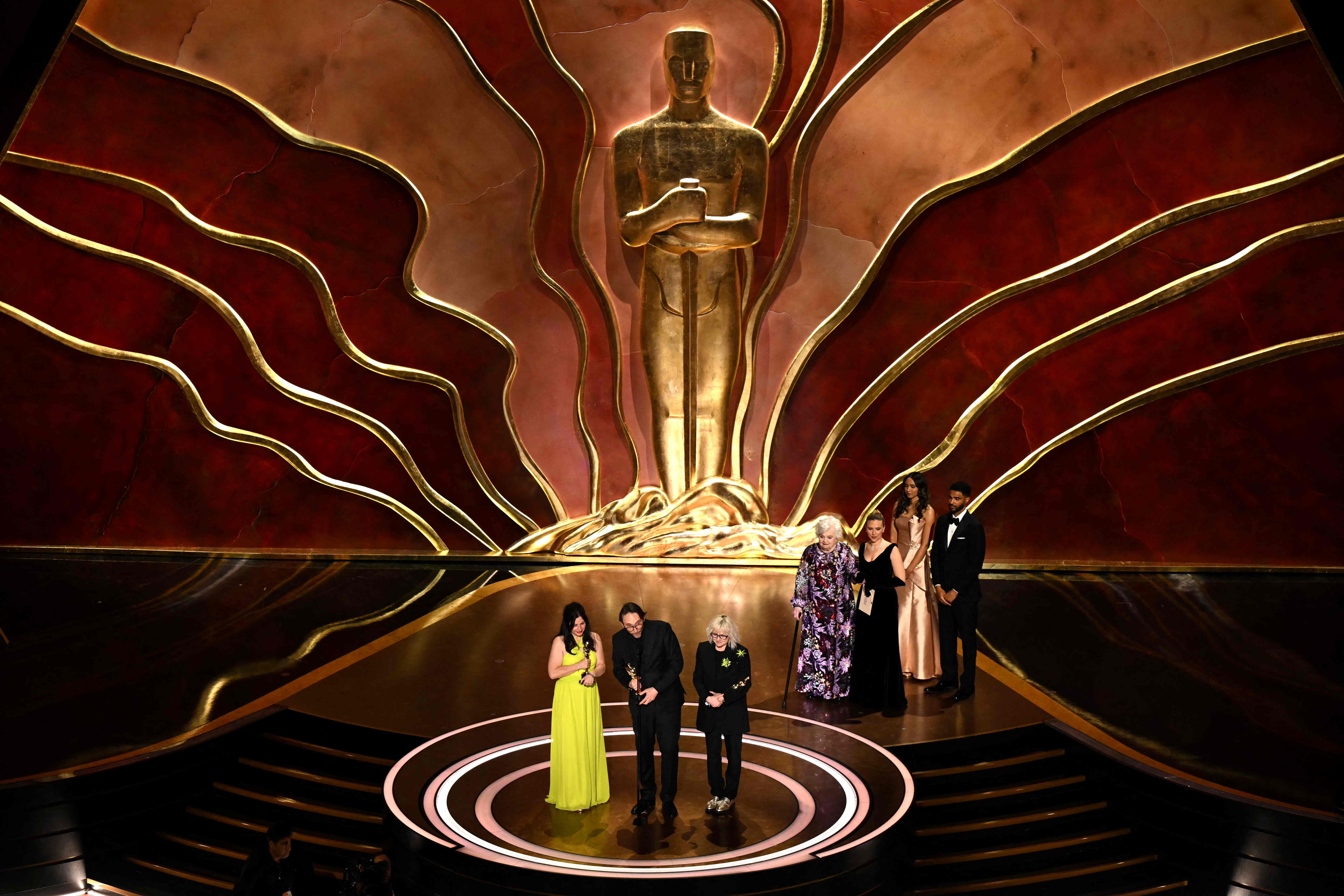 (L/R) French Makeup Artist Marilyne SCARSELLI, Pierre-Loivier Persin and Stephanie Guillon Accept the Award for Best Makeup and Hairstyling For "The Substance" Ostage During the 97th Annual Academy Awards at The Dolby Theater in Hollywood, California on March 2, 2025. (Photo by Patrick T. Fallon / AFP)