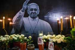 A portrait of Pope Francis is seen as Catholic faithful pray during a requiem mass for Pope Francis at the Surabaya Cathedral, also known as the Hati Kudus Yesus church in Surabaya, on April 22, 2025. Pope Francis died of a stroke, the Vatican announced hours after the death of the 88-year-old reformer who inspired devotion but riled traditionalists during 12 years leading the Catholic Church on April 21. (Photo by Juni KRISWANTO / AFP)