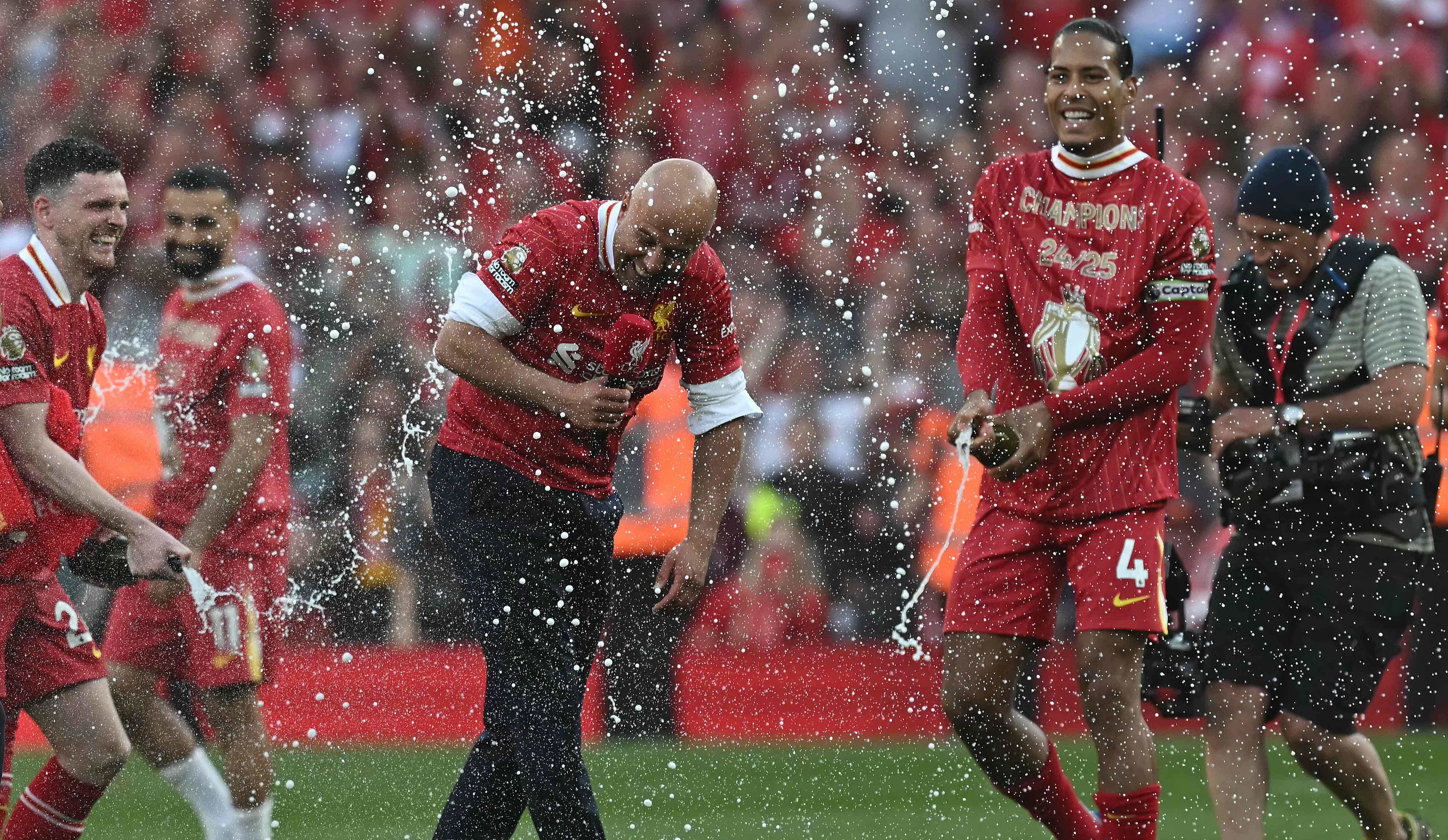 Liverpool's Dutch Manager Arne Slot Reacts As Liverpool's Dutch Defender #04 Virgil Van Dijk (R) and Liverpool's Scottish Defender #26 Andrew Robertson Spray Him with champagne After The English Premier League Football Match Between Liverpool and Tottenham HotsPur AT ANFIELD IN LIVERPOOL, North West England On April 27, 2025. Liverpool Won the Match 5-1, Making Them The Winners of the Premier League Title. (Photo by Paul Ellis / AFP) / restricted to Editorial Use. Do not use with unauthorized audio, video, data, fixture lists, club/league logos or 'live' service. Online In-Match Use Limited to 120 images. An additional 40 images may be used in extra time. No emulation video. Social Media Media In-Match Use Limited to 120 images. An additional 40 images may be used in extra time. Do not use in Betting Publications, Games or Single Club/League/Public Publications. /