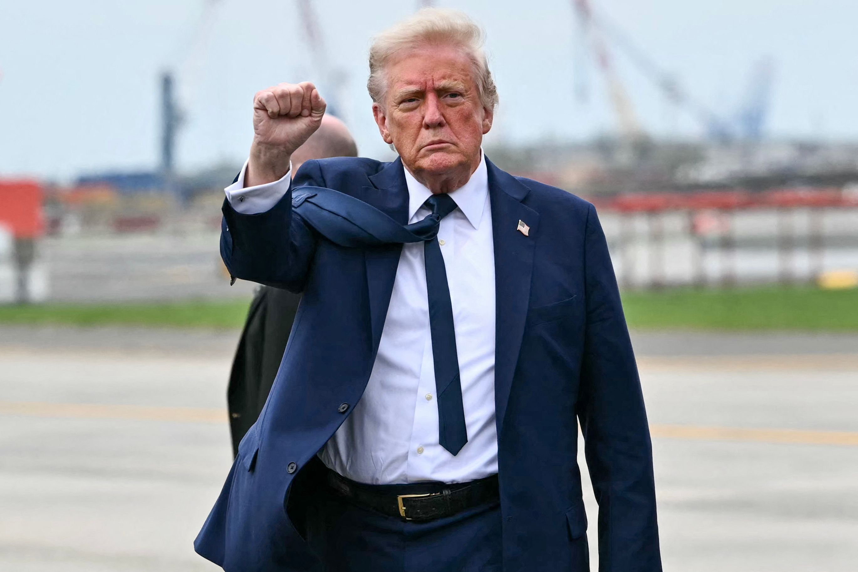US President Donald Trump pumps his fist as he steps off Air Force upon arrival at Newark Liberty International Airport in Newark, New Jersey on April 26, 2025. (Photo by Mandel NGAN / AFP)
