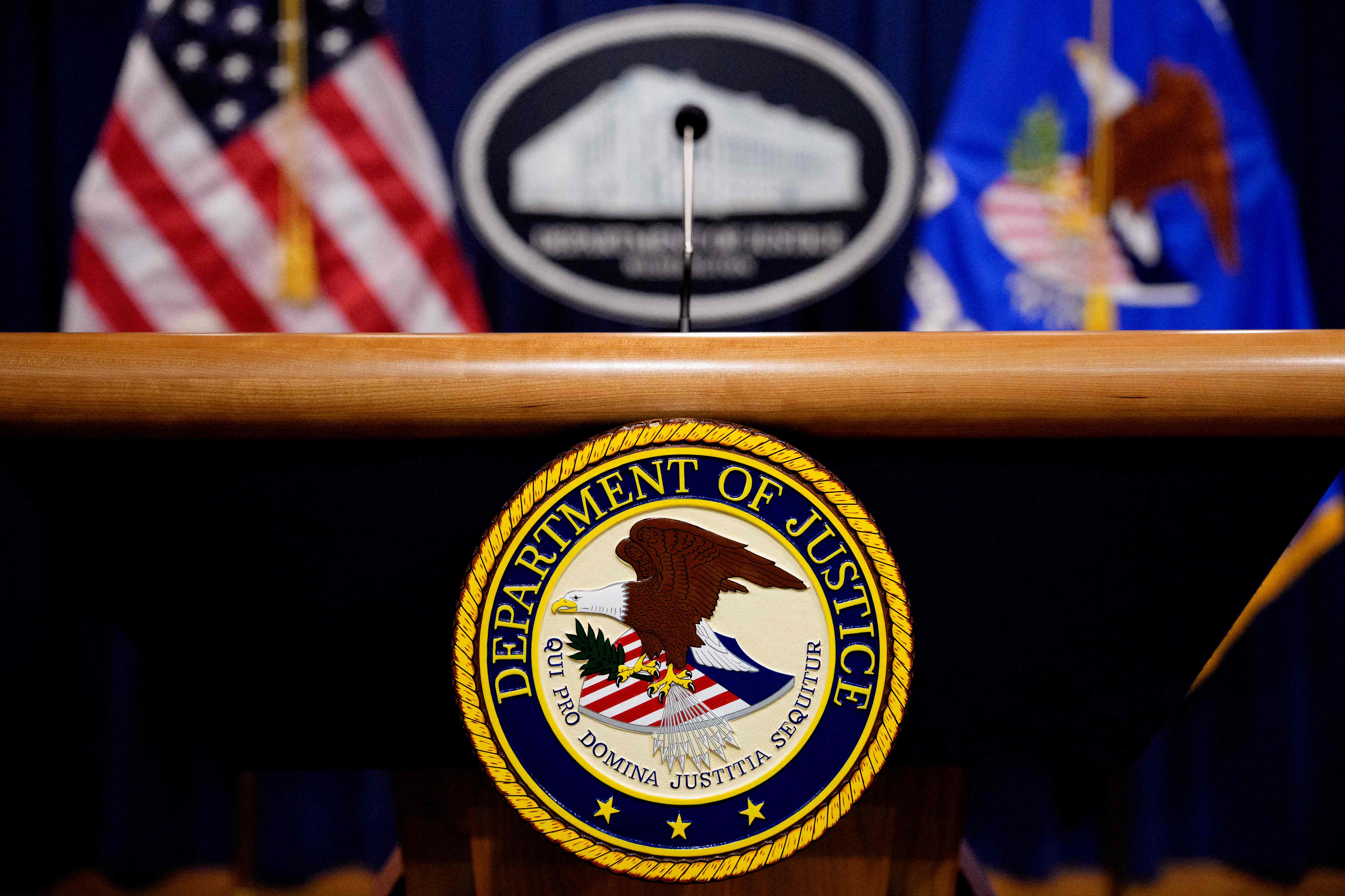 WASHINGTON, DC - MAY 6: The Department of Justice seal and logo are displayed before U.S. Attorney General Pam Bondi arrives for a news conference at the Department of Justice on May 6, 2025 in Washington, DC. The Justice Department along with the Drug Enforcement Administration (DEA) and the U.S. Attorney's Office for the District of New Mexico are set to announce that they have completed an operation targeting a large drug trafficking organization that has been dealing fentanyl and other illicit narcotics.   Andrew Harnik/Getty Images/AFP (Photo by Andrew Harnik / GETTY IMAGES NORTH AMERICA / Getty Images via AFP)