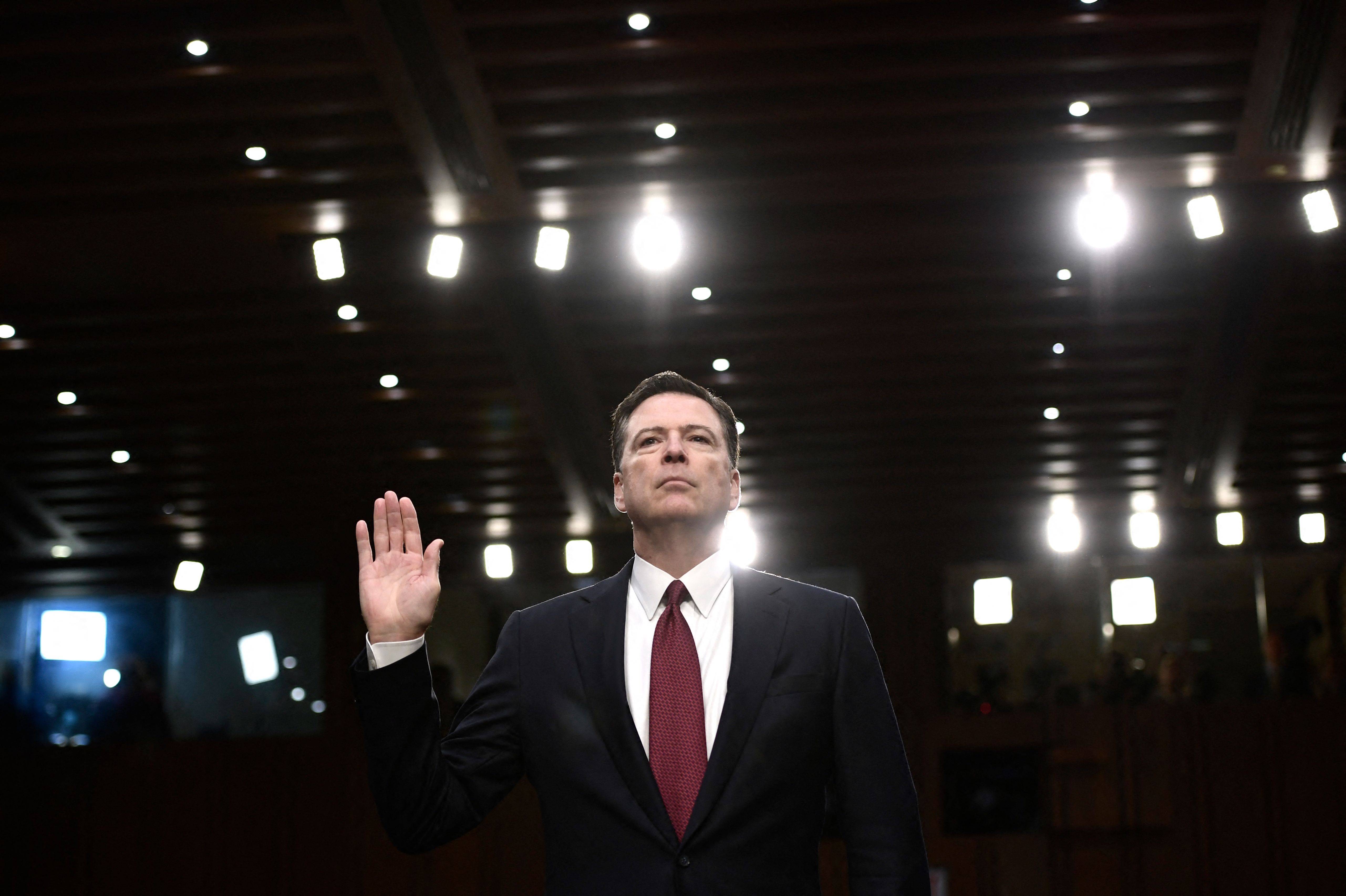 (FILES) Former FBI Director James Comey takes the oath before he testifies during a US Senate Select Committee on Intelligence hearing on Capitol Hill in Washington, DC, June 8, 2017. On May 16, Donald Trump labeled former FBI director James Comey a "dirty cop" over a social media post that the US president deemed a veiled call for assassination and which prompted a Secret Service probe.
Comey made a now-deleted post on Instagram the previous day that showed an image of "86 47" spelled out in sea shells, with "86" being slang for kill and Trump the 47th president. (Photo by Brendan Smialowski / AFP)