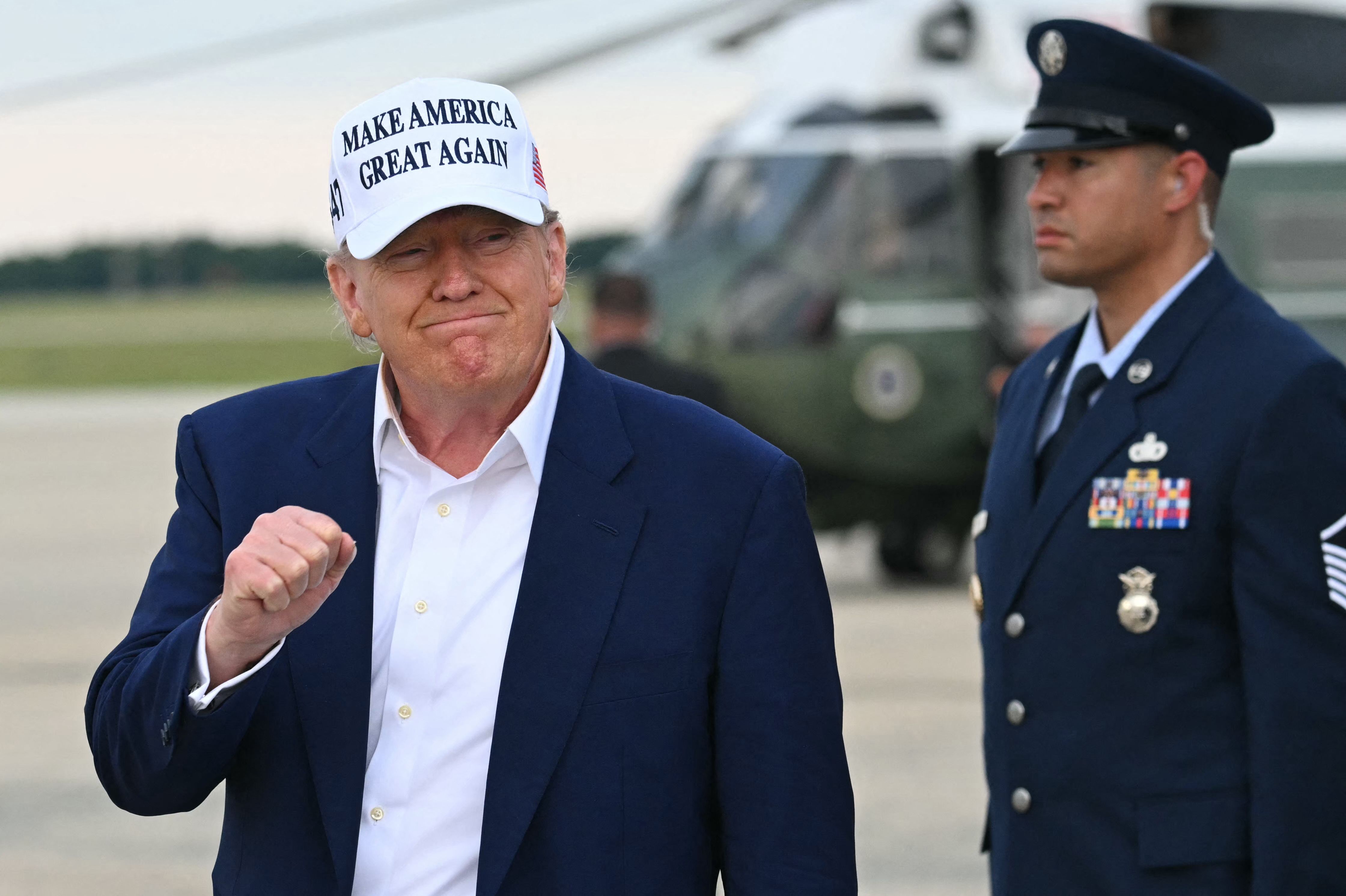 US President Donald Trump makes a fist as he disembarks from Air Force One upon arrival at Joint Base Andrews in Maryland, May 25, 2025, after spending the weekend in New Jersey. (Photo by SAUL LOEB / AFP)