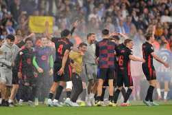 Barcelona players celebrate after winning their Spanish league football match between RCD Espanyol and FC Barcelona at the RCDE Stadium in Cornella de Llobregat, on May 15, 2025. (Photo by MANAURE QUINTERO / AFP)