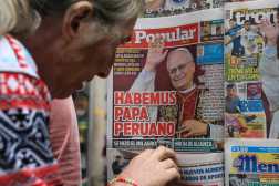 A woman looks at the front pages of Peruvian newspapers celebrating the naming of US Cardinal Robert Prevost as the new Pope Leo XIV at a newsstand in downtown Lima on May 9, 2025. Prevost was elected pope on May 8, 2025. The US-born pontiff, close to Pope Francis, became a Peruvian national in 2015 and dedicated more than 20 years as a missionary in Peru. (Photo by CONNIE FRANCE / AFP)