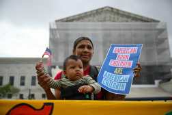 TOPSHOT - Olga Urbina and her 9 months son Ares Webster participate in a protest outside the US Supreme Court over President Donald Trump's move to end birthright citizenship as the court hears arguments over the order in Washington, DC, on May 15, 2025. Trump issued an executive order on his first day in office seeking to limit birthright citizenship for children whose parents are in the United States illegally or on temporary visas, but it has been blocked in multiple appellate courts. He appealed the case to the Supreme Court on March 13. (Photo by Drew ANGERER / AFP)
