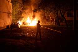 A man walks near a fire following a drone strike in Kharkiv on June 5, 2025, amid Russian invasion in Ukraine. (Photo by Oleksandr Magula / AFP)