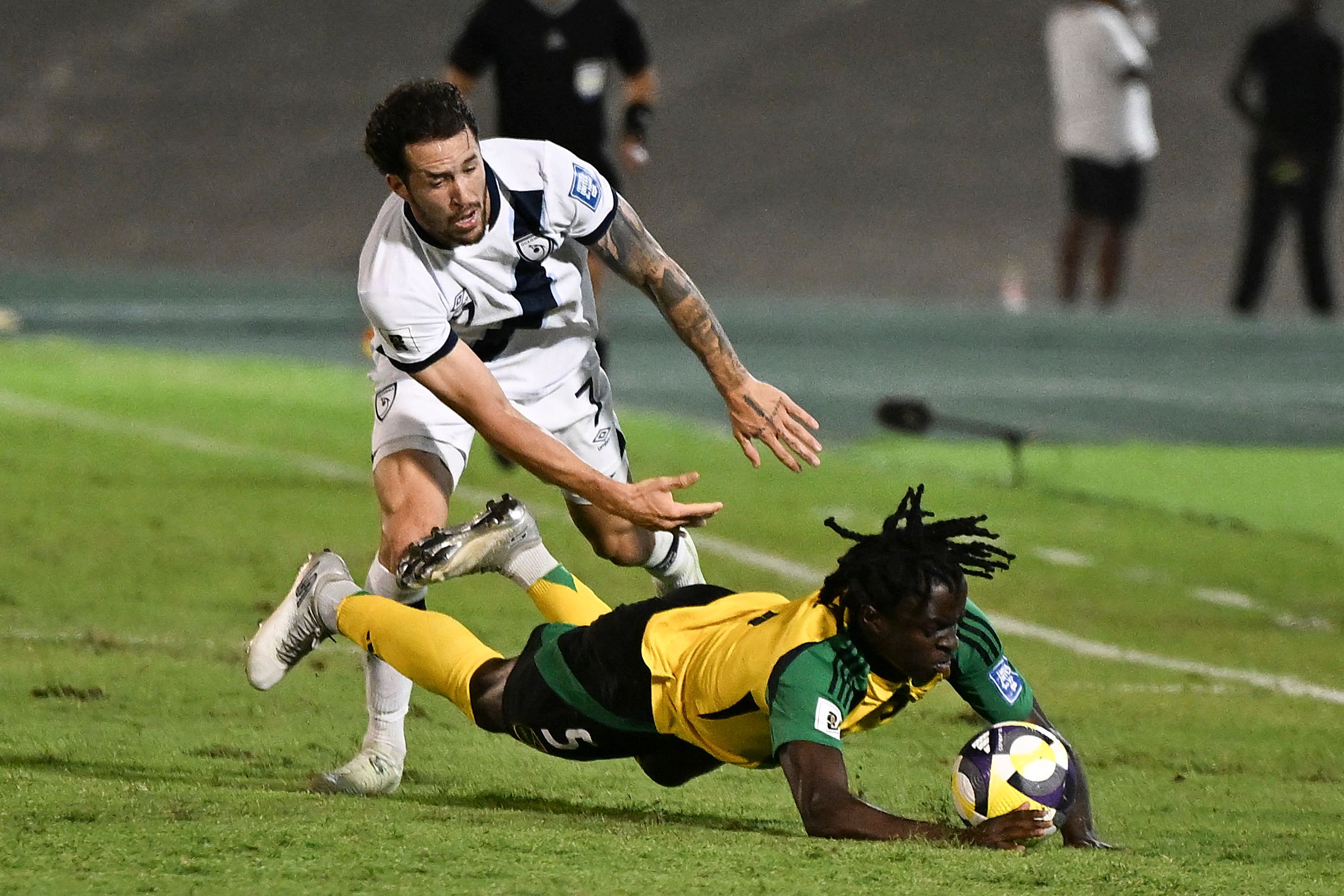 Guatemala's defender #07 Aaron Herrera and Jamaica's forward #05 Tyreece Campbell fight for the ball during the 2026 FIFA World Cup Concacaf qualifier football match between Jamaica and Guatemala at the Independence Park stadium in Kingston on June 10, 2025. (Photo by Ricardo Makyn / AFP)
