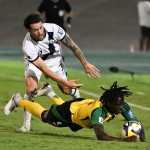 Guatemala's defender #07 Aaron Herrera and Jamaica's forward #05 Tyreece Campbell fight for the ball during the 2026 FIFA World Cup Concacaf qualifier football match between Jamaica and Guatemala at the Independence Park stadium in Kingston on June 10, 2025. (Photo by Ricardo Makyn / AFP)