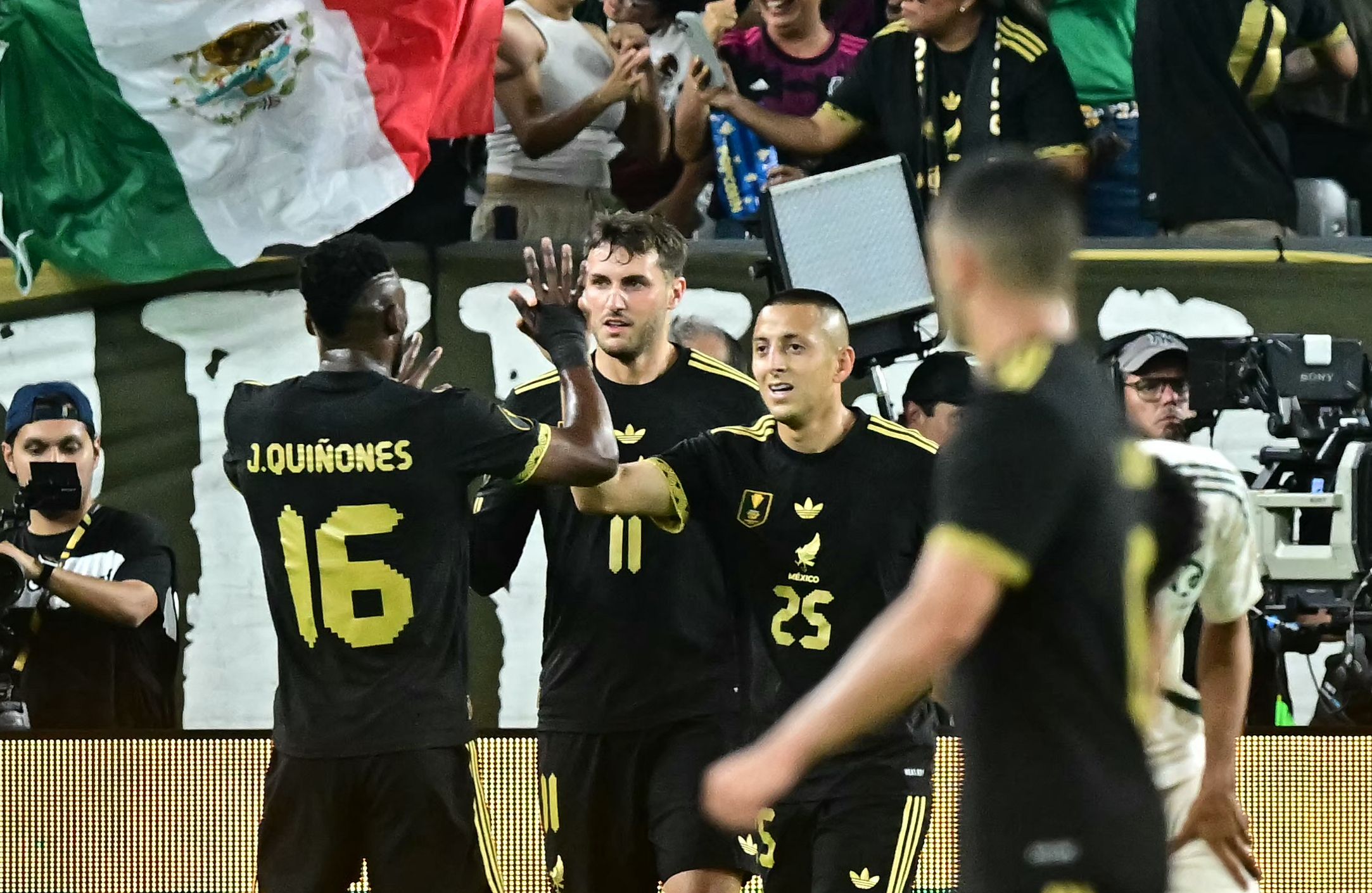 Mexico's forward #16 Julián Quiñones and Mexico's midfielder #25 Roberto Alvarado celebrate a goal during the CONCACAF Gold Cup quartefinal match between Mexico and Saudi Arabia at State Farm Stadium in Glendale, Arizona on June 28, 2025. (Photo by Frederic J. Brown / AFP)