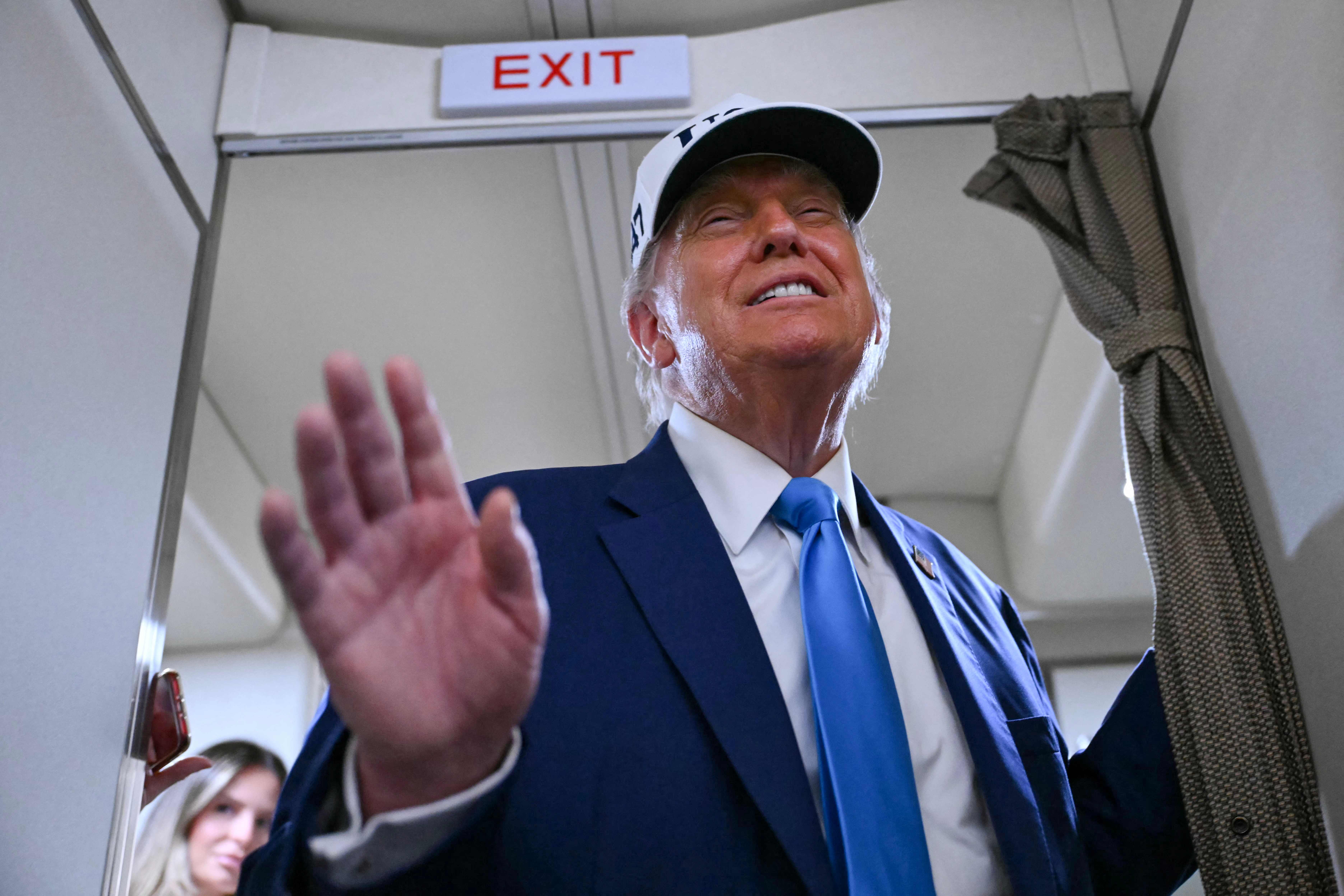 US President Donald Trump talks to the press aboard Air Force One on the way to Morristown Municipal Airport in Morristown, New Jersey, on June 6, 2025. Trump is travelling to his residence and golf club in Bedminster, New Jersey. (Photo by ANDREW CABALLERO-REYNOLDS / AFP)