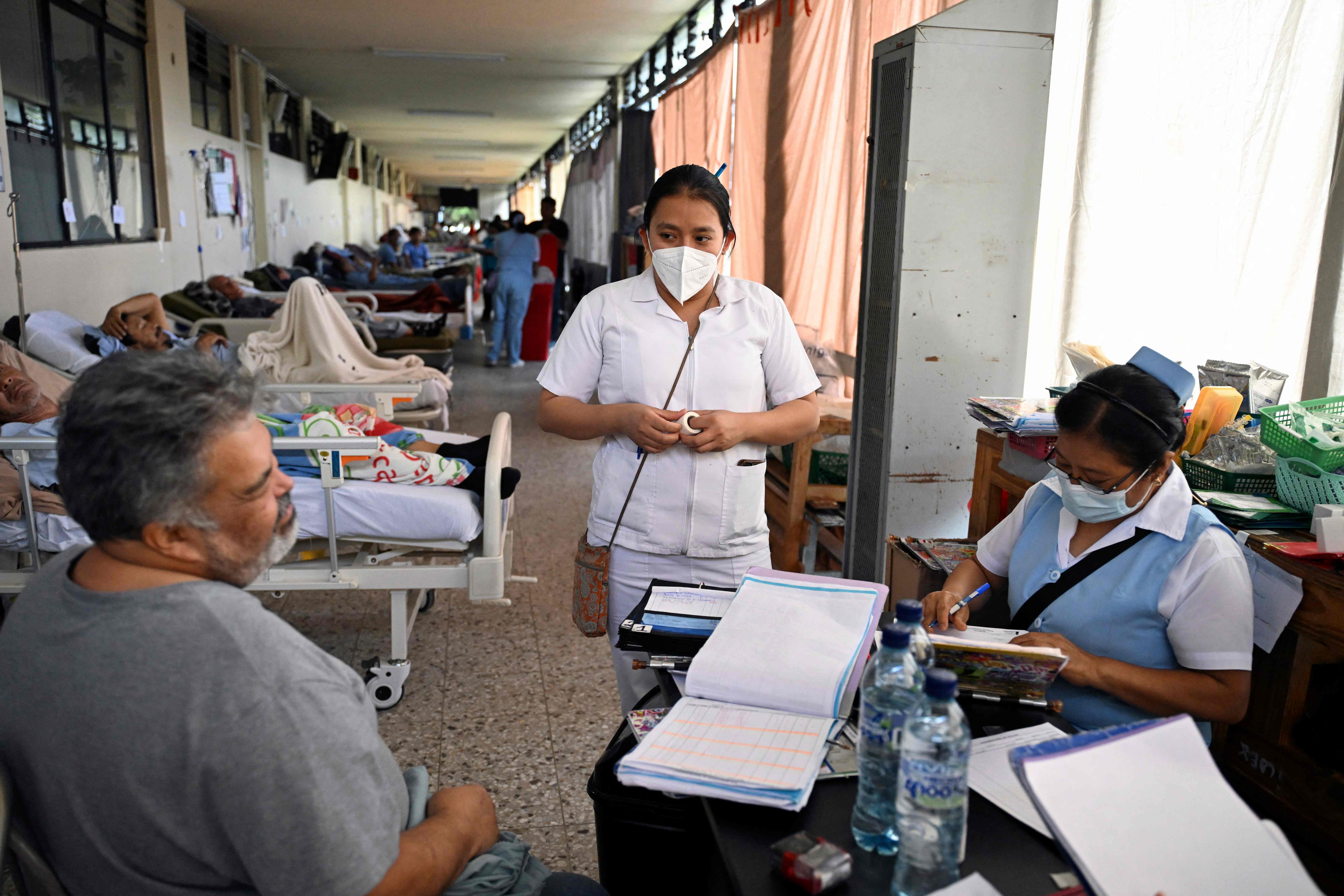 Nurses assist patients in a safe area of El Hermano Pedro Hospital, where they were relocated after several earthquakes in Antigua, Guatemala, on July 9, 2025. The swarm of earthquakes that has been affecting Guatemala since Tuesday has caused at least four deaths, affected some 650 people, and damaged around 100 homes, civil protection authorities reported on Wednesday. (Photo by JOHAN ORDONEZ / AFP)