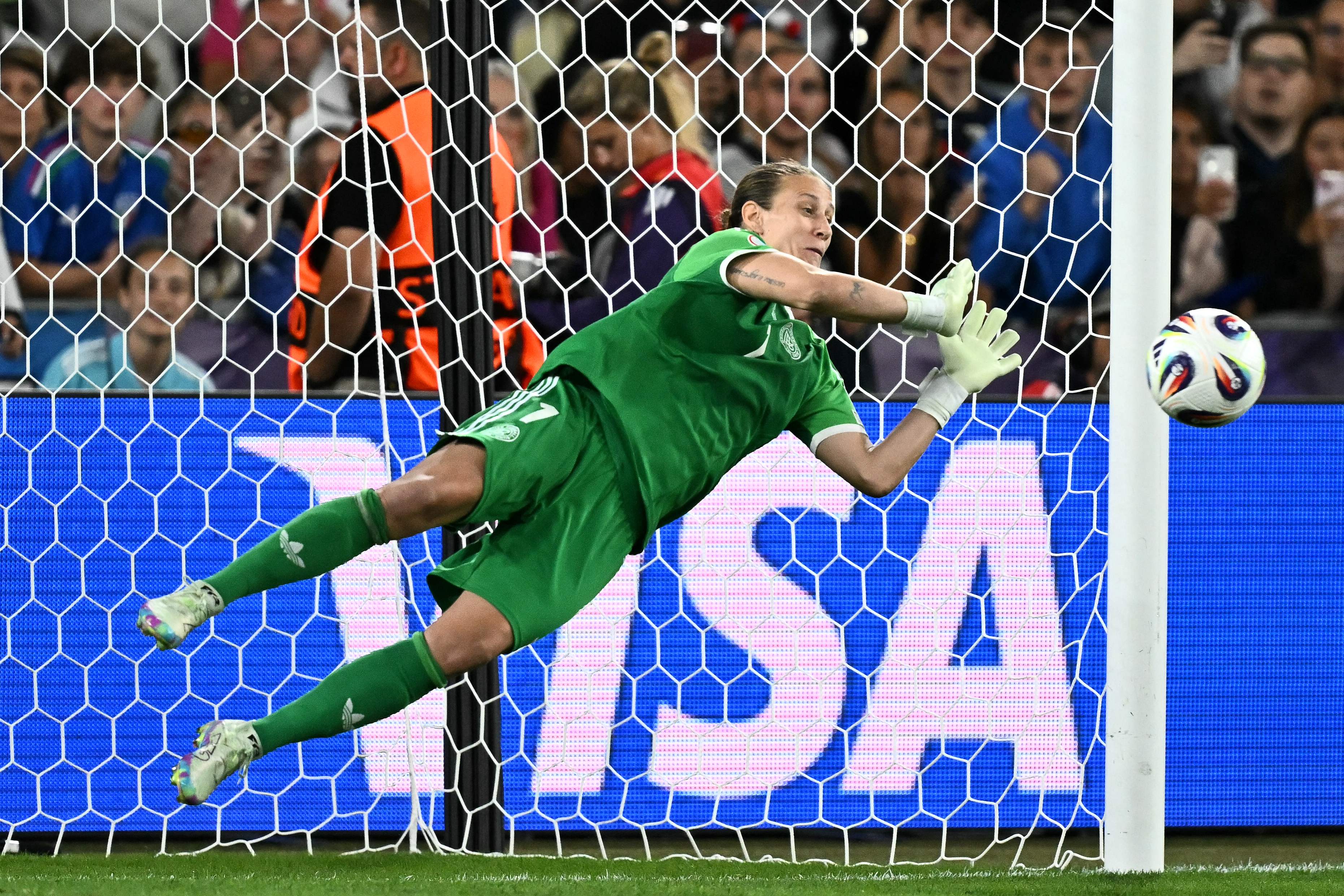 Germany's goalkeeper #01 Ann-Katrin Berger saves France's first penalty during a penalty shootout at the end of the extra time in the UEFA Women's Euro 2025 quarter finals football match between France and Germany at the Parc Saint-Jacques (St. Jakob Park) stadium in Basel, on July 19, 2025. (Photo by Fabrice COFFRINI / AFP)
