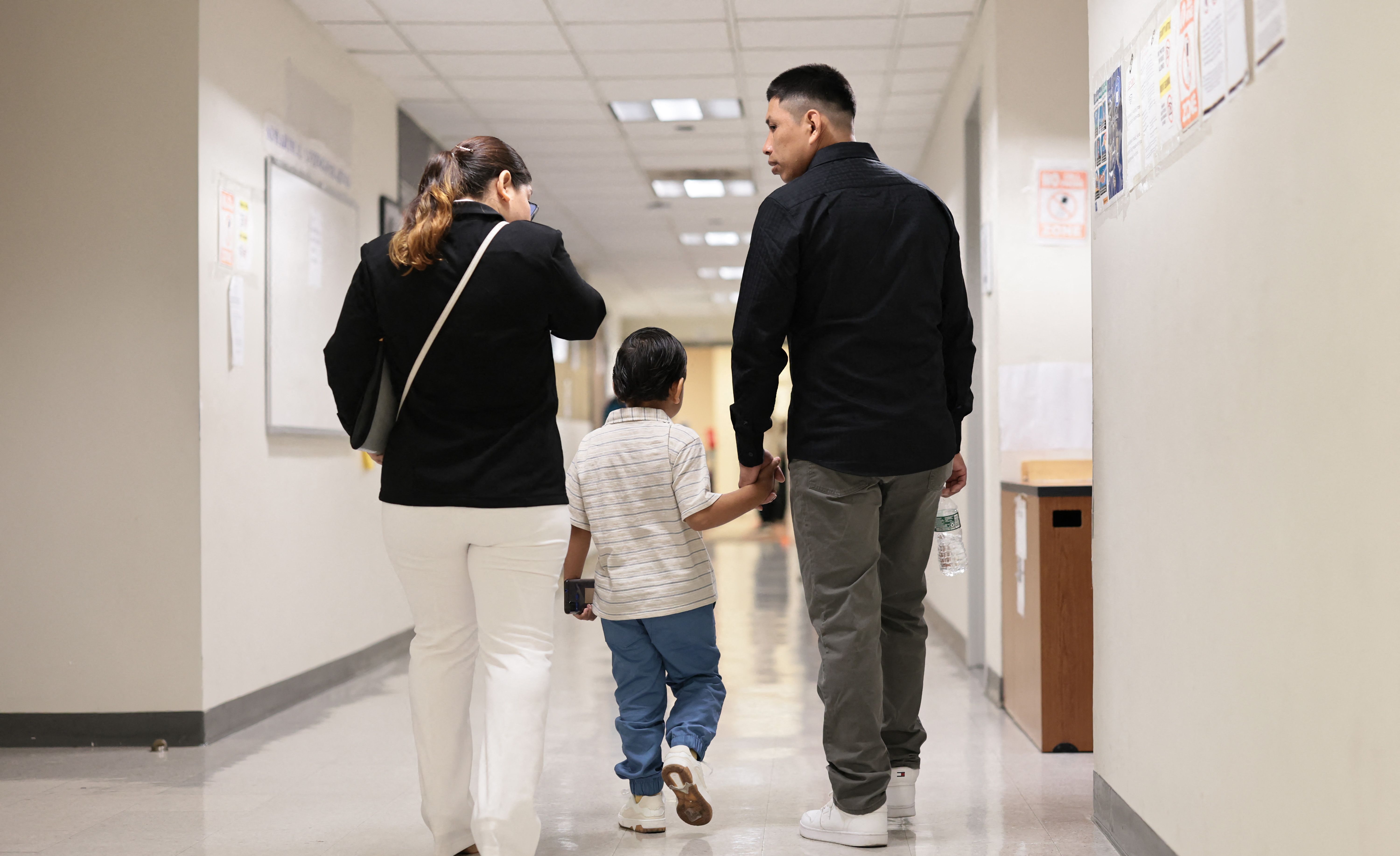NEW YORK, NEW YORK - AUGUST 04: People arrive for their hearings in immigration court at the Jacob K. Javitz Federal Building on August 04, 2025 in New York City. The Department of Homeland Security (DHS) is offering new Immigration and Customs Enforcement (ICE) recruits signing bonuses of up to $50,000 and student loan forgiveness as the agency is seeking to meet U.S. President Donald Trumps goal of hiring 10,000 new ICE agents and deporting a million people a year.   Michael M. Santiago/Getty Images/AFP (Photo by Michael M. Santiago / GETTY IMAGES NORTH AMERICA / Getty Images via AFP)