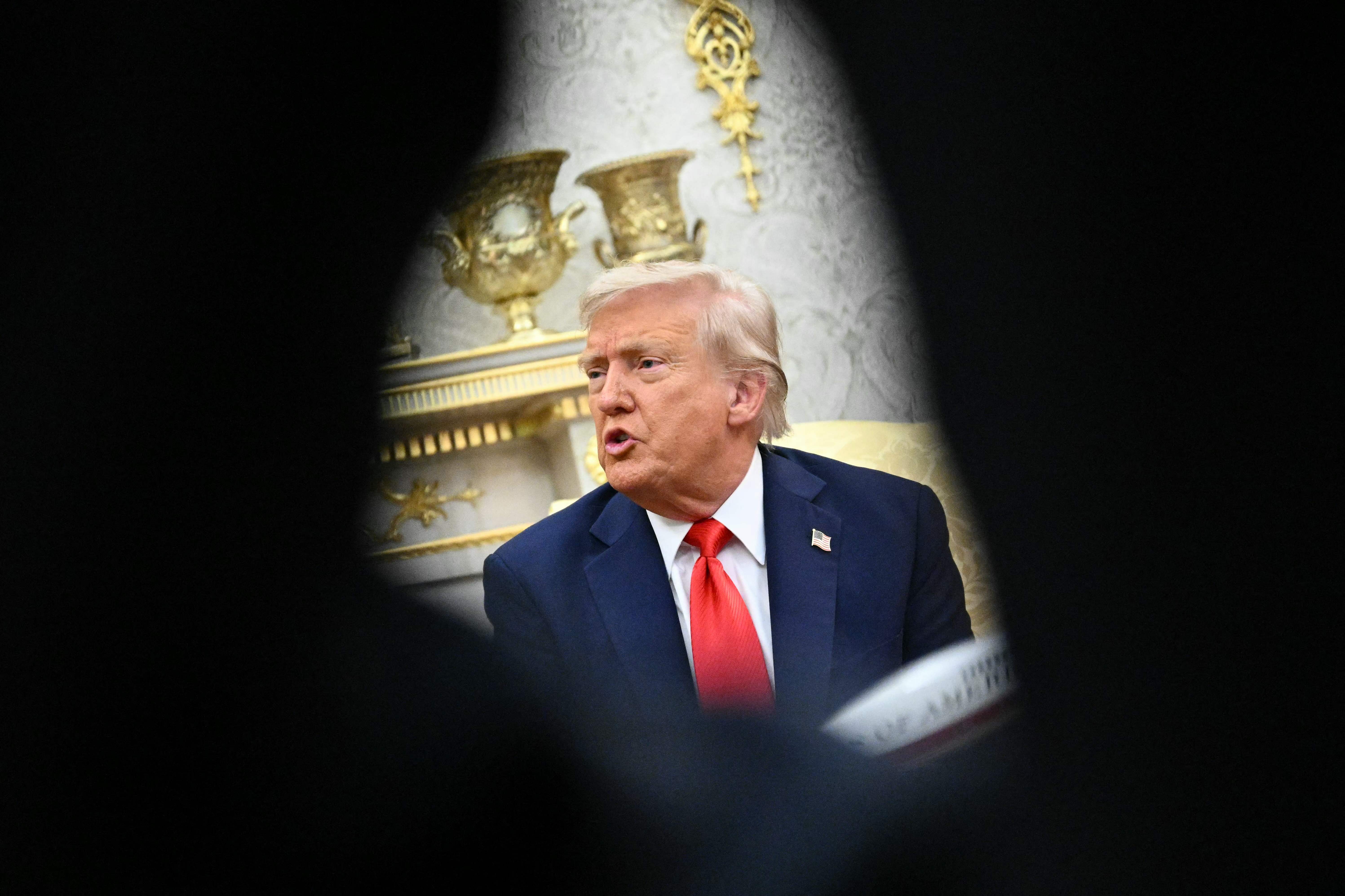 US President Donald Trump speaks during a bilateral meeting with South Korean President Lee Jae Myung in the Oval Office of the White House in Washington, DC, on August 25, 2025. Trump on Monday suggested that a "purge or revolution" was underway in South Korea, hours before new President Lee Jae Myung was due at the White House. He did not specify to what he was referring but said he would bring it up with Lee. (Photo by Mandel NGAN / AFP)