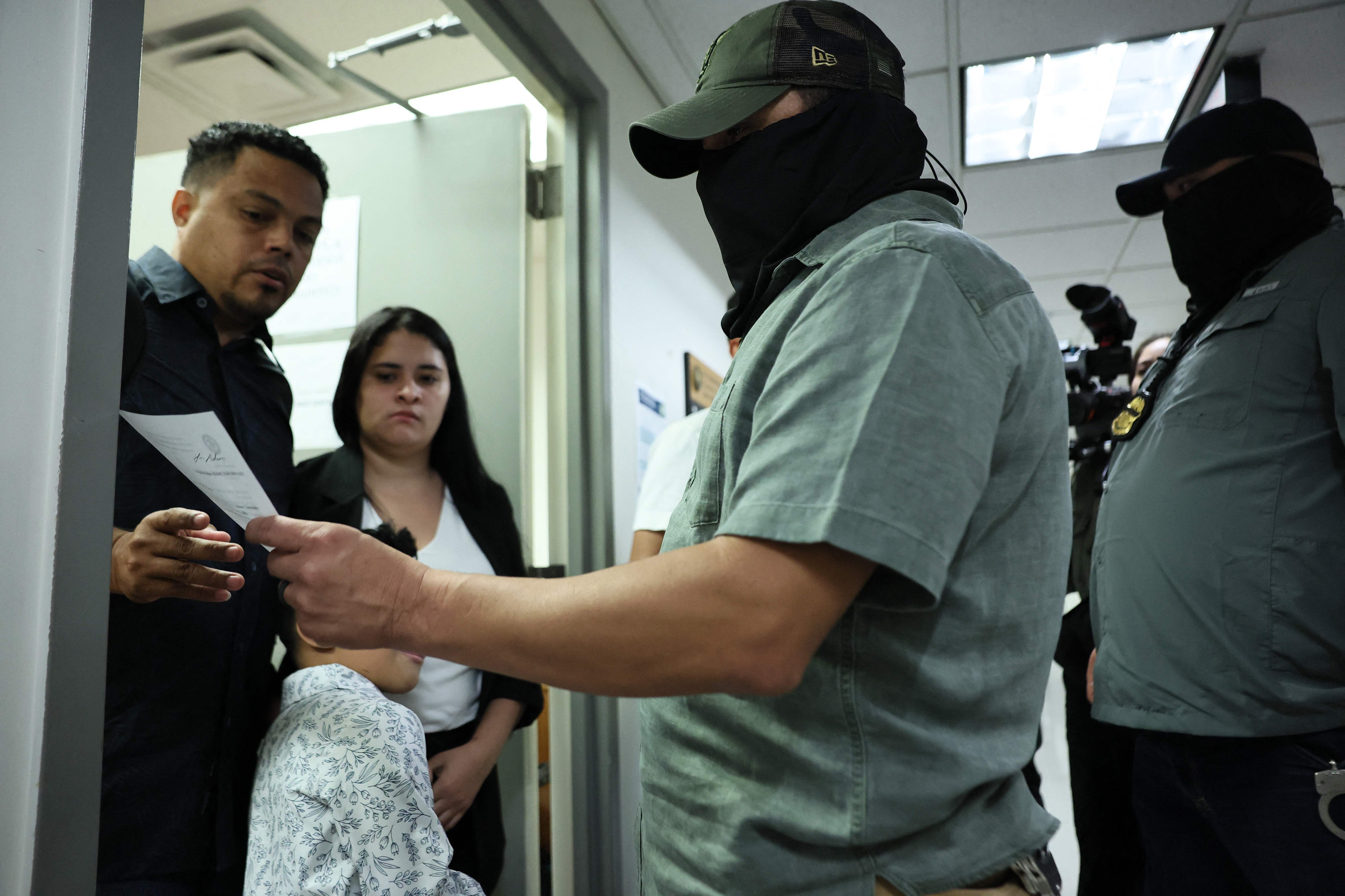 NEW YORK, NEW YORK - SEPTEMBER 03: Federal agents checks the name of a man as he exited immigration court with his family before being let go at the Jacob K. Javitz Federal Building on September 03, 2025 in New York City. Immigration and Customs Enforcement (ICE) agents and other federal agencies continue to make detainments in immigration courts as people attend their court hearings. According to data from the Deportation Data Project ICE has deported more than three times the number of immigrant New Yorkers who were removed in all of last year, mostly driven by driven by detainments at 26 Federal Plaza.   Michael M. Santiago/Getty Images/AFP (Photo by Michael M. Santiago / GETTY IMAGES NORTH AMERICA / Getty Images via AFP)