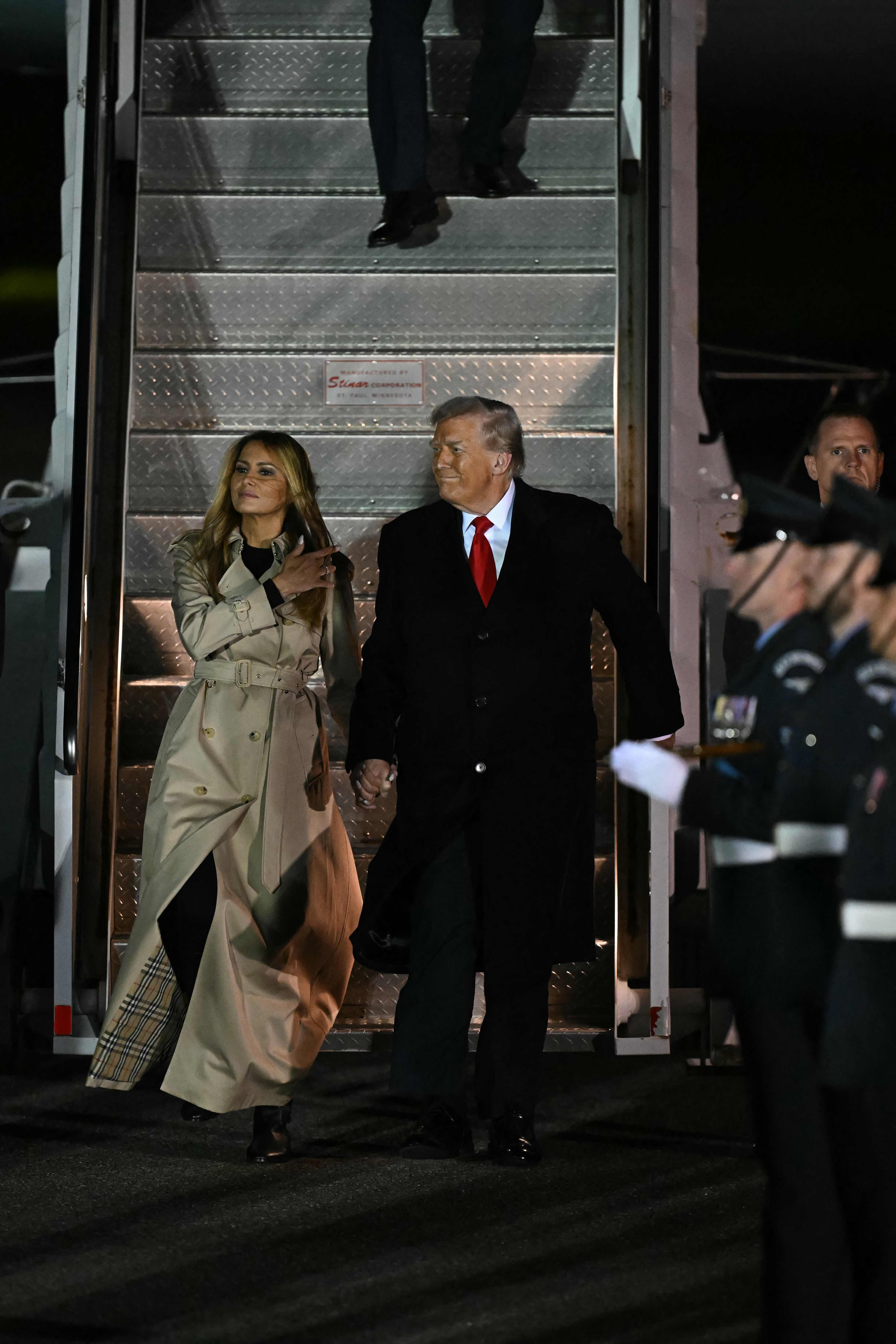 US President Donald Trump and US First Lady Melania Trump disembark from Air Force One after landing at Stansted Airport, eastern England, on September 16, 2025, on the first day of a two-day visit to the UK. US President Donald Trump arrived in the UK late Tuesday for a State Visit with his wife, Melania, a rare privilege made at the invitation of King Charles III. (Photo by Paul ELLIS / AFP)