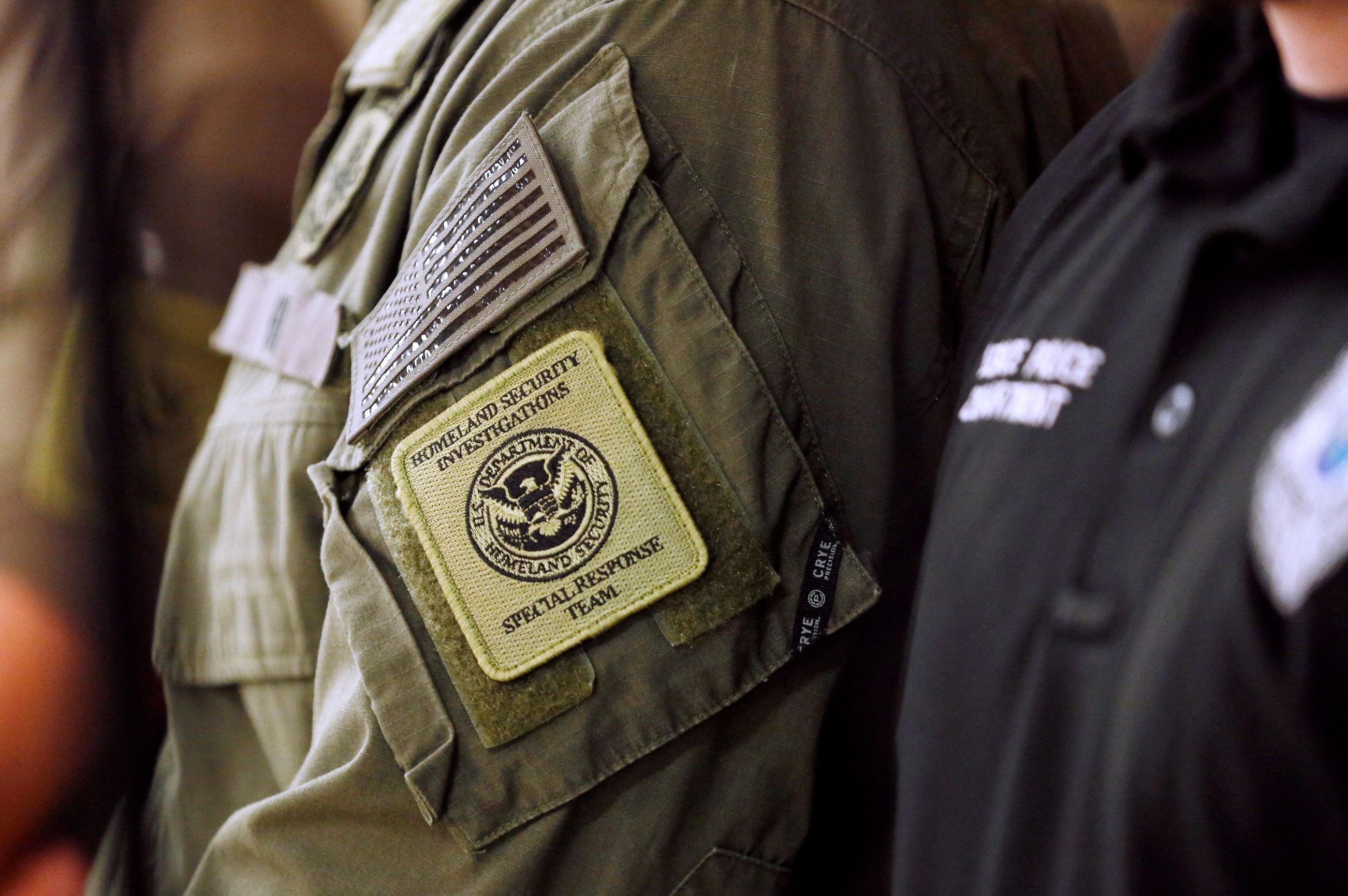 BRADENTON, FLORIDA - OCTOBER 20: A member of the Homeland Security Investigations Special Response Team is seen wearing his uniform during Department of Homeland Security Secretary Kristi Noem's press conference at a federal office building on October 20, 2025 in Bradenton, Florida. The Secretary addressed ongoing immigration enforcement efforts and federal coordination with local authorities across the state, while praising President Donald Trump for their joint accomplishments under the "One, Big, Beautiful Bill," which received congressional approval and funded expanded DHS operations.   Octavio Jones/Getty Images/AFP (Photo by Octavio Jones / GETTY IMAGES NORTH AMERICA / Getty Images via AFP)