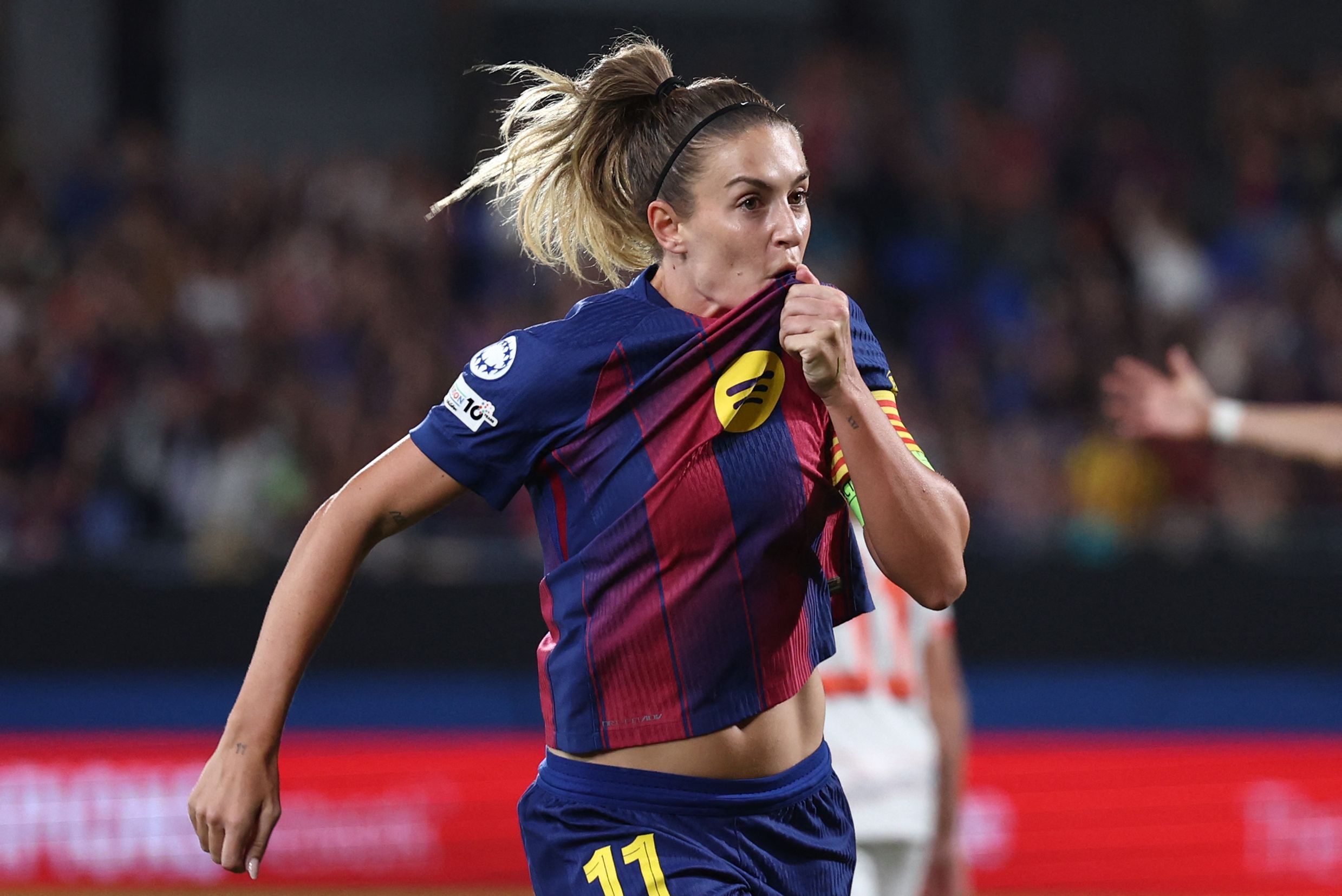 Barcelona's Spanish midfielder #11 Alexia Putellas celebrates scoring her team's first goal during the Women's Champions League, league phase day 1 football match between FC Barcelona and Bayern Munich at Johan Cruyff Stadium in Barcelona on October 7, 2025. (Photo by Josep LAGO / AFP)