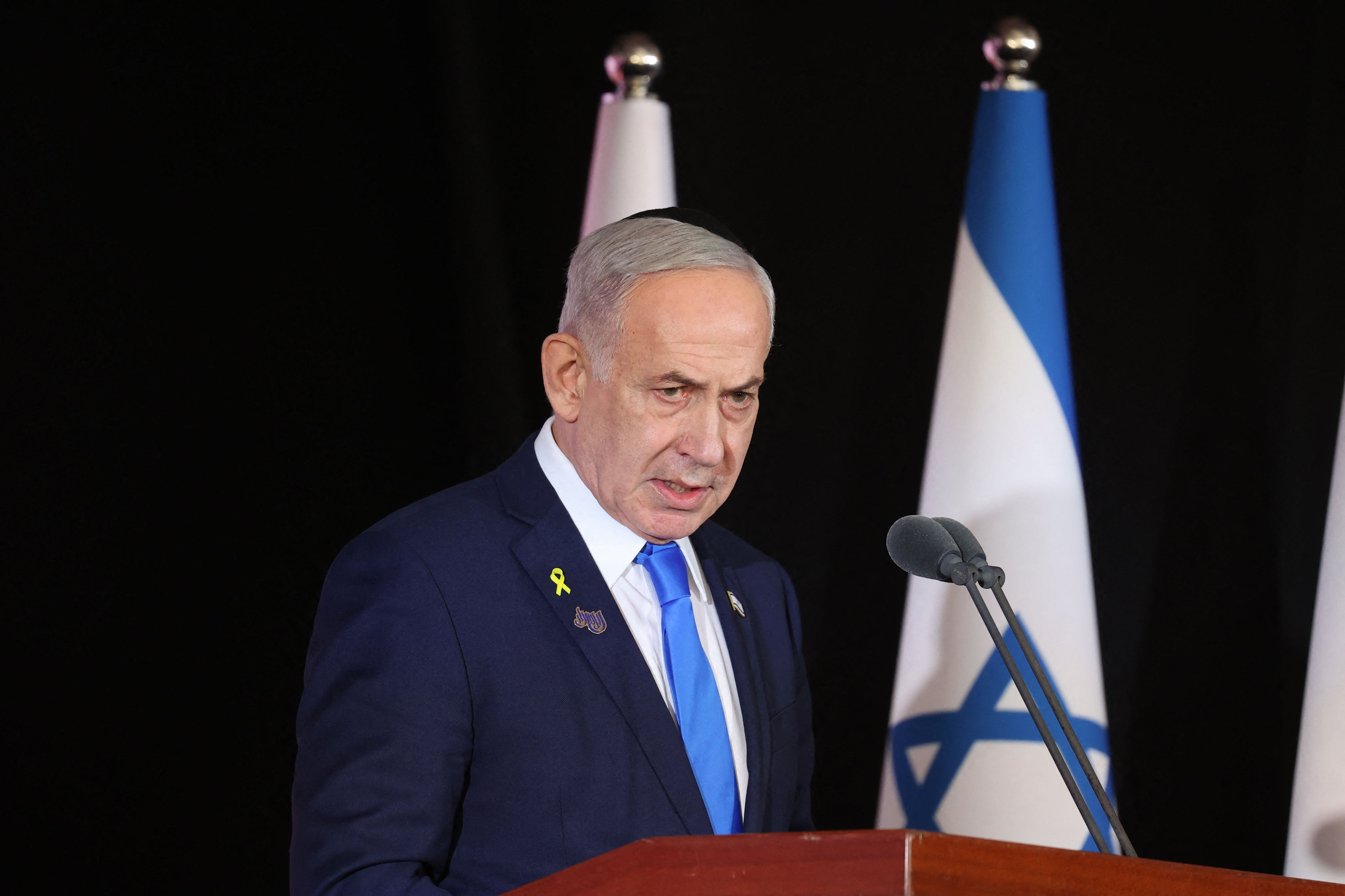 Israeli Prime Minister Benjamin Netanyahu participates in a state memorial ceremony for the fallen soldiers of the two-year Gaza war at the Mount Herzl military cemetery in Jerusalem on October 16, 2025. Netanyahu said on October 16, that he was determined to ensure that Hamas hands back the remains of hostages still in Gaza, adding that the fight "is not over yet". (Photo by Alex KOLOMOISKY / POOL / AFP)