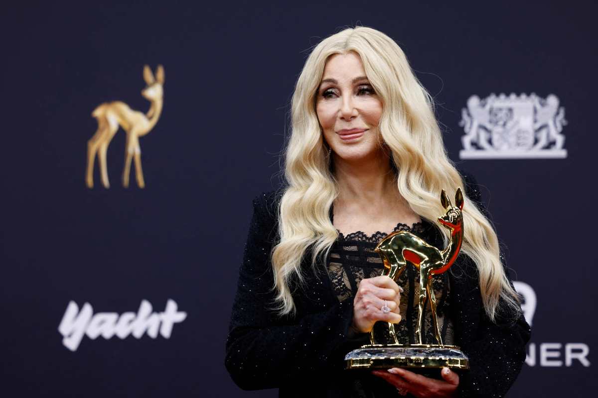 US singer Cher poses with her Bambi award as icon of art and humanity during the ceremony for the German media award Bambi in Munich, southern Germany on November 13, 2025. (Photo by Michaela STACHE / AFP)