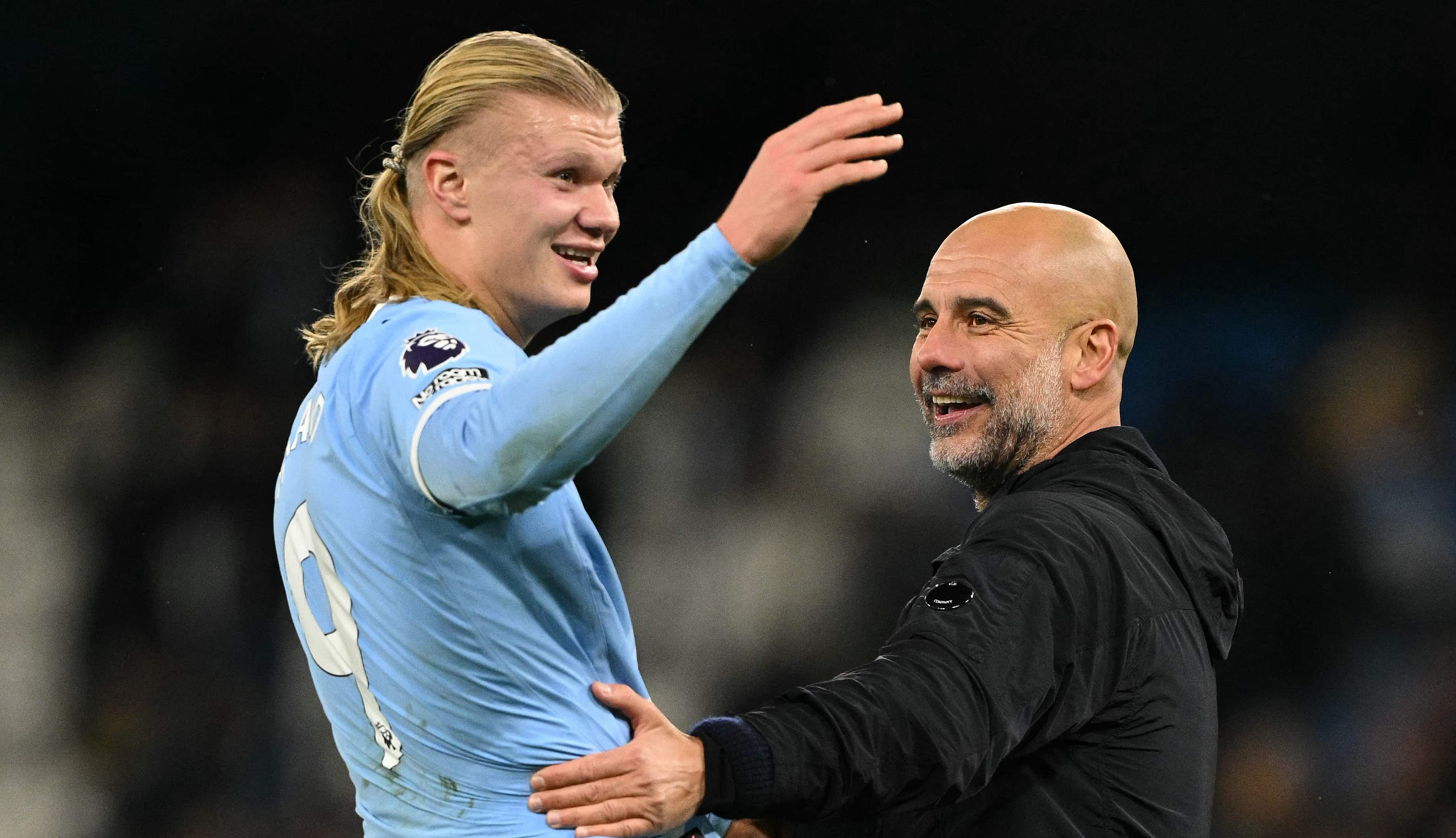 Manchester City's Norwegian striker #09 Erling Haaland (L) reacts with Manchester City's Spanish manager Pep Guardiola after the English Premier League football match between Manchester City and Leeds United at the Etihad Stadium in Manchester, north west England, on November 29, 2025. (Photo by Oli SCARFF / AFP) / RESTRICTED TO EDITORIAL USE. No use with unauthorized audio, video, data, fixture lists, club/league logos or 'live' services. Online in-match use limited to 120 images. An additional 40 images may be used in extra time. No video emulation. Social media in-match use limited to 120 images. An additional 40 images may be used in extra time. No use in betting publications, games or single club/league/player publications. /