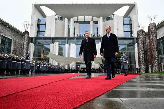 German Chancellor Friedrich Merz (R) and Croatia's Prime Minister Andrej Plenkovic are pictured during a welcoming ceremony in the courtyard of the Chancellery in Berlin on December 10, 2025. (Photo by Tobias SCHWARZ / AFP)