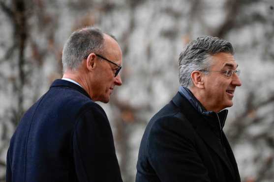 German Chancellor Friedrich Merz (L) and Croatia's Prime Minister Andrej Plenkovic are pictured during a welcoming ceremony in the courtyard of the Chancellery in Berlin on December 10, 2025. (Photo by Tobias SCHWARZ / AFP)