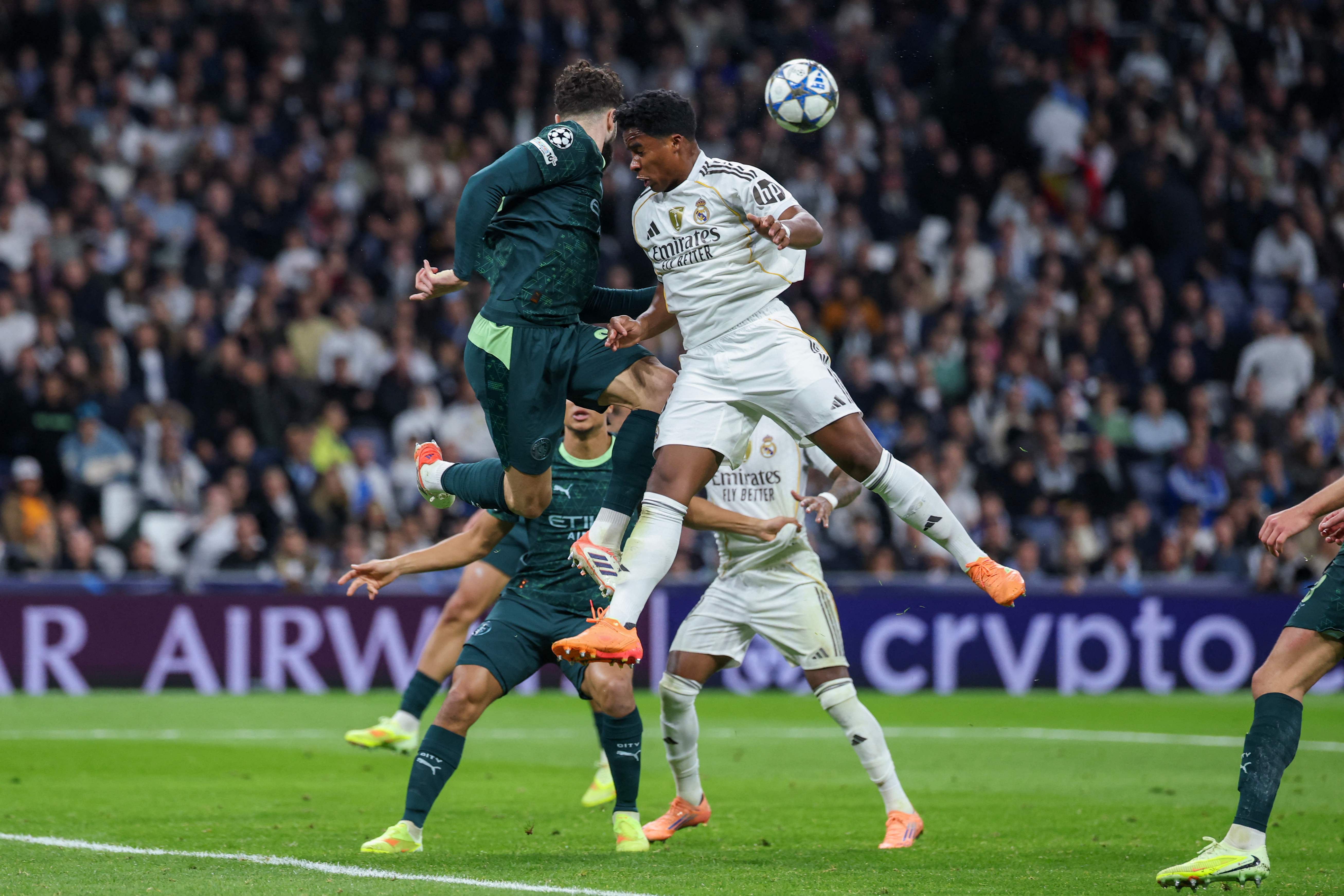 Real Madrid's Brazilian forward #09 Endrick (C) goes for a header during the UEFA Champions League league phase day 6 football match between Real Madrid CF and Manchester City at Santiago Bernabeu Stadium in Madrid on December 10, 2025. (Photo by Thomas COEX / AFP)