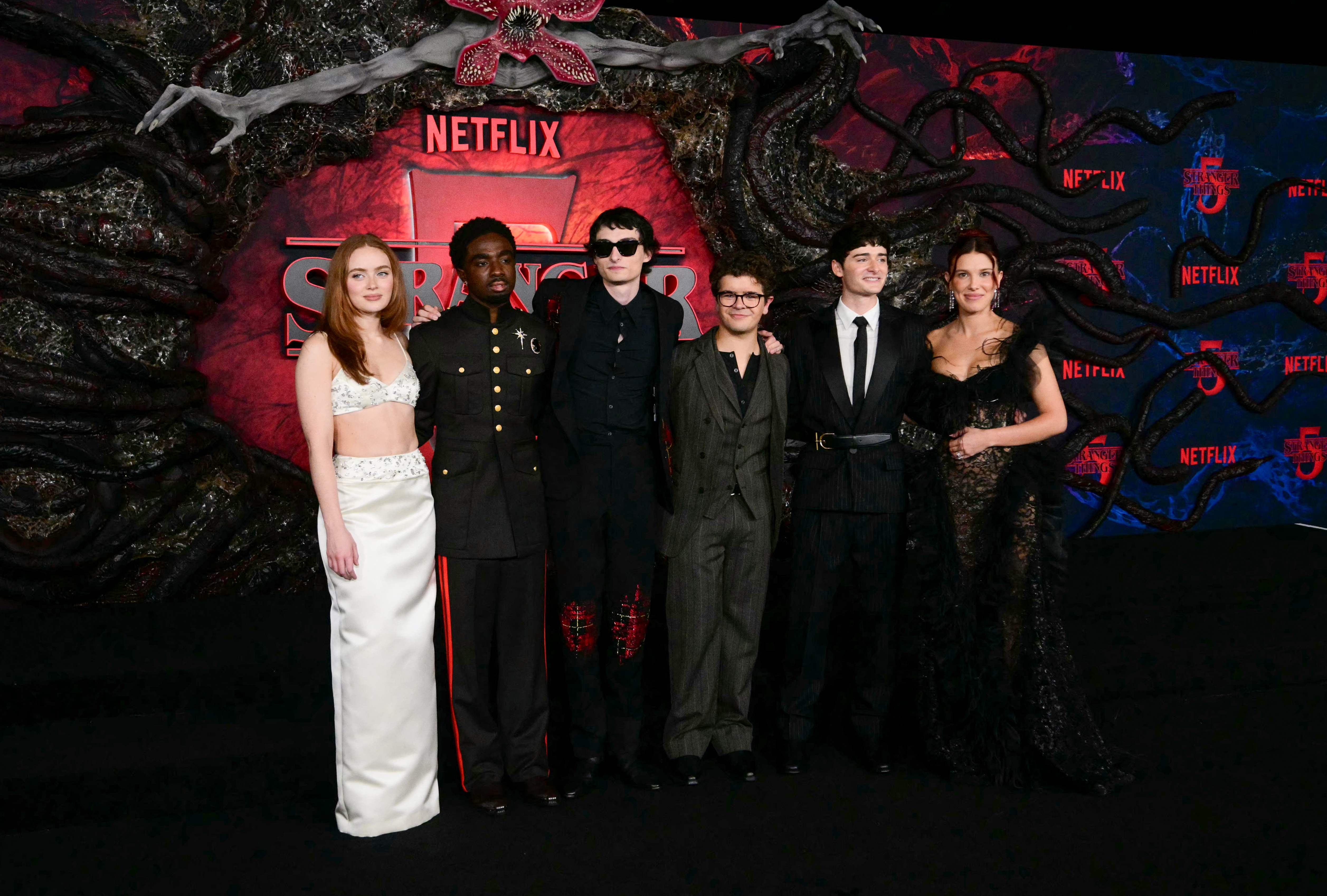 (FILES) (L/R) US actors Sadie Sink, Caleb McLaughlin, Canadian actor Finn Wolfhard, US actors Gaten Matarazzo, Noah Schnapp and British actress Millie Bobby Brown attend the world premiere of Netflix's "Stranger Things", Season 5, at the TCL Chinese theatre in Los Angeles on November 6, 2025. The hit fantasy series Stranger Things returns to Netflix on December 26, 2025 for three new episodes of the fifth and final season, before the grand finale on January 1st. (Photo by Frederic J. Brown / AFP)